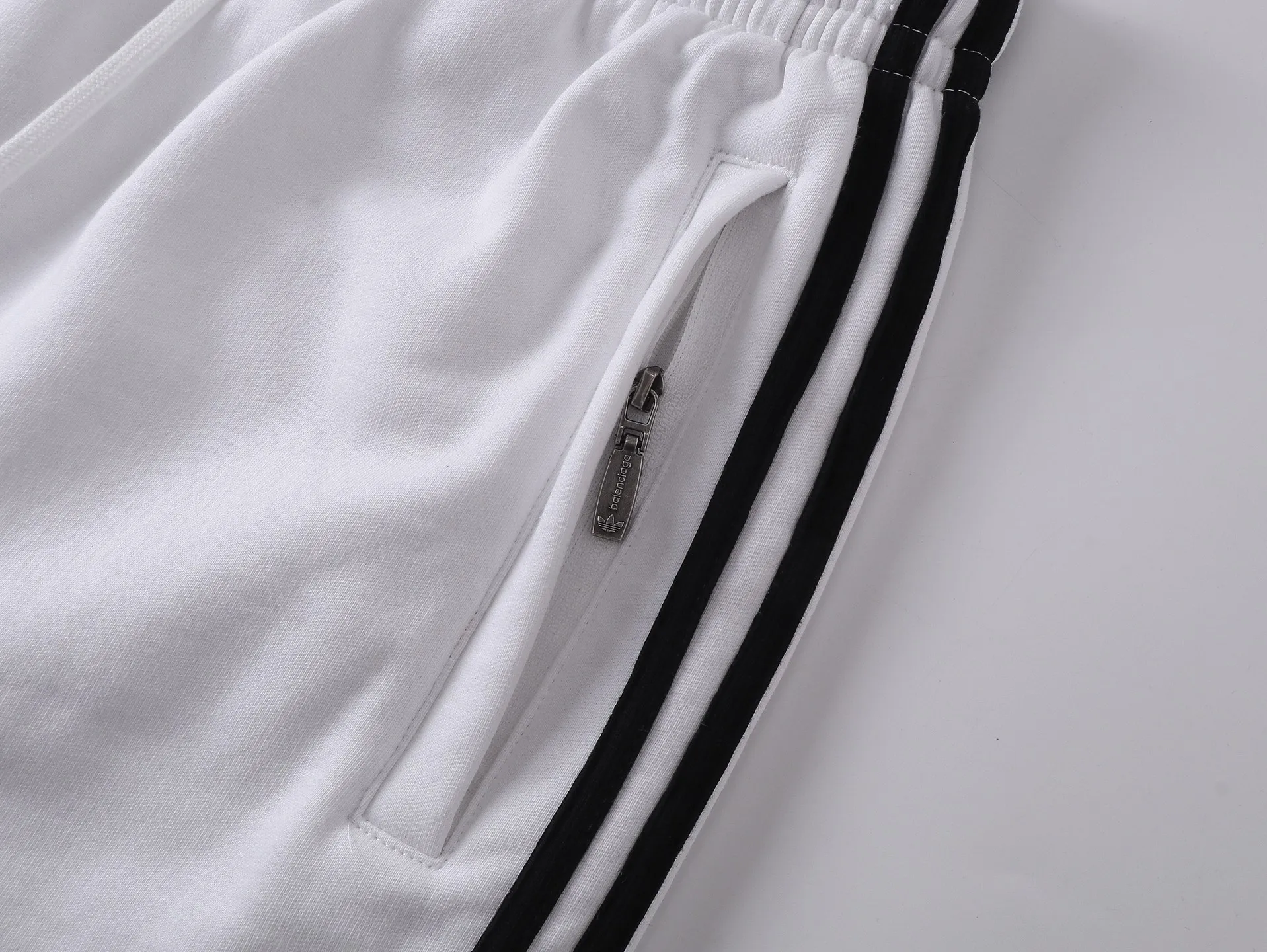 🅿️240 real shots [Top version. Official website quality] BALENCI*GA/Paris. 2025 new model. Paris co-branded adidas clover embroidered side seams. Invisible zipper shorts at the pocket. Brick cabinet synchronization. Genuine product developed at the first time, please print and compare! The fabric is made of Paris ZP custom-woven and dyed 100% cotton terry sweatshirt. The weight is 460 grams. The cloth surface is clean. The cloth pattern is clear and the hand feels soft and comfortable. The embroidery uses an imported Tajima embroidery machine. The letters are clear and the effect is three-dimensional. The version adopts a loose version. Same style for men and women. Code: BL257029 Color: black, white Size: XS S M L