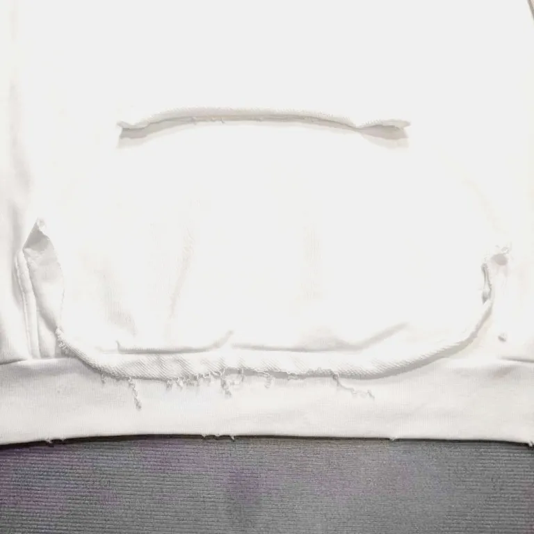 The top proven version of Balenciaga 23SS masking paper printed letters double-sided logo hooded loose hooded sweatshirt. This hoodie has a very interesting and cute design. The kangaroo pocket on the front of the large body is reverse-cut design. The double side pockets are hollow, which means that when viewed from the front, it actually deceives your vision. The real pockets are sewn on the reverse terry bottom. It is time-consuming and labor-intensive, but it is the core theme of the entire hoodie that cannot be ignored. The same detail is that the double side pockets are hemmed and stitched. And processed with holes; 480g heavy-weight pure cotton fabric with fine small terry bottom. After heavy mud dyeing and washing, the fabric still has a thick foundation and is comfortable and soft. The front and back double-sided textured paper transfer LOGO, and the front and back printing colors are different. The loose and large drop shoulder design is unisex. This style is also very suitable for girls to match. It is easy to create a lazy and casual street feel of the United States and France. Many holes are processed by hand grinding wheels on the body. Traces of muddying can be seen on the neckline, shoulder line, and side cuff splicing, but the visual effect transition is natural and soft without any sense of dirt. The old effect of the entire hoodie is excellent. The cuff threads are custom-woven in color; the packaging is washed and customized. The new gray silver letter main logo. The dropped shoulder model does not include shoulder width. The version is Kanye’s American style. Short and wide street casual version. From short sleeves to sweaters, this style is definitely not to be missed. Color: mud-dyed custom-woven navy Size: XS-S-M (Can be worn by both men and women, OS is loose and dropped on the shoulders) P:510