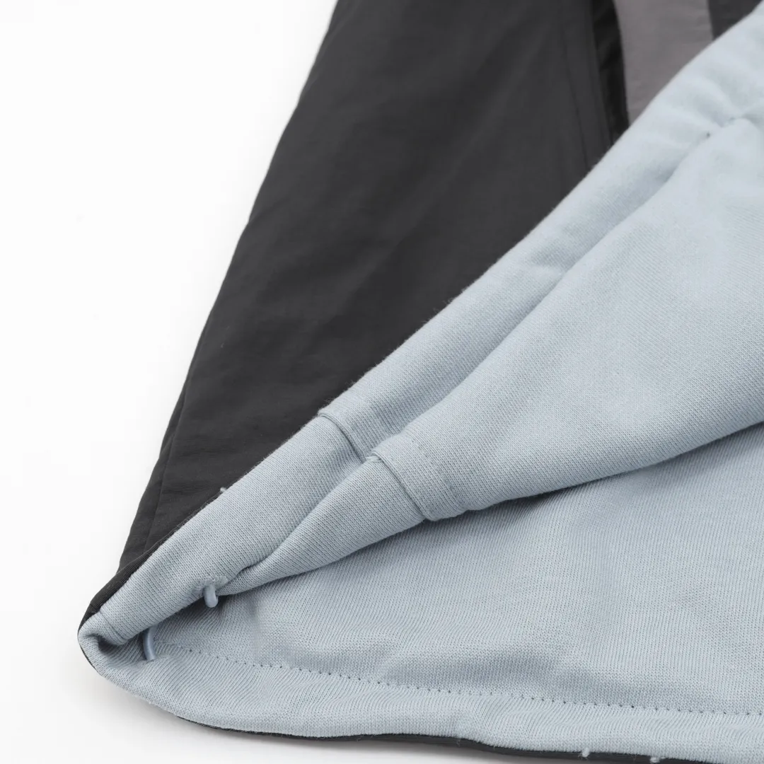 🅿️620 Balenciaga x Under Armor Balenciaga BLCG × UA 25SS cross-border co-branded haze blue reversible jacket Light luxury essential item for daily commuting for men and women Correct version Free comparison Detailed features · Customized matte Taslan jacket fabric · The entire fabric is pre-treated with a waterproof coating · OS ultra-loose silhouette design · The reverse side is made of custom-dyed 360g double-yarn pure cotton terry fabric · Custom-dyed cotton matte tatami embroidery thread · Imported Tajima high-speed embroidery machine high-density machine embroidery, three-dimensional and full · Side zipper pockets hooded design · The reverse side of the sweatshirt is designed with a sweatshirt rat bag · The cuffs are designed with elastic elasticity · The hem is designed with elastic spring buckles to tighten the waist · Open mold customization hardware zipper spring buckle Customized logo hood cord · Zippered pockets on the side of trousers · Three-grade polyester bird’s eye mesh lining · Original main mark washed tag packaging Color: Black Size: 46-52
