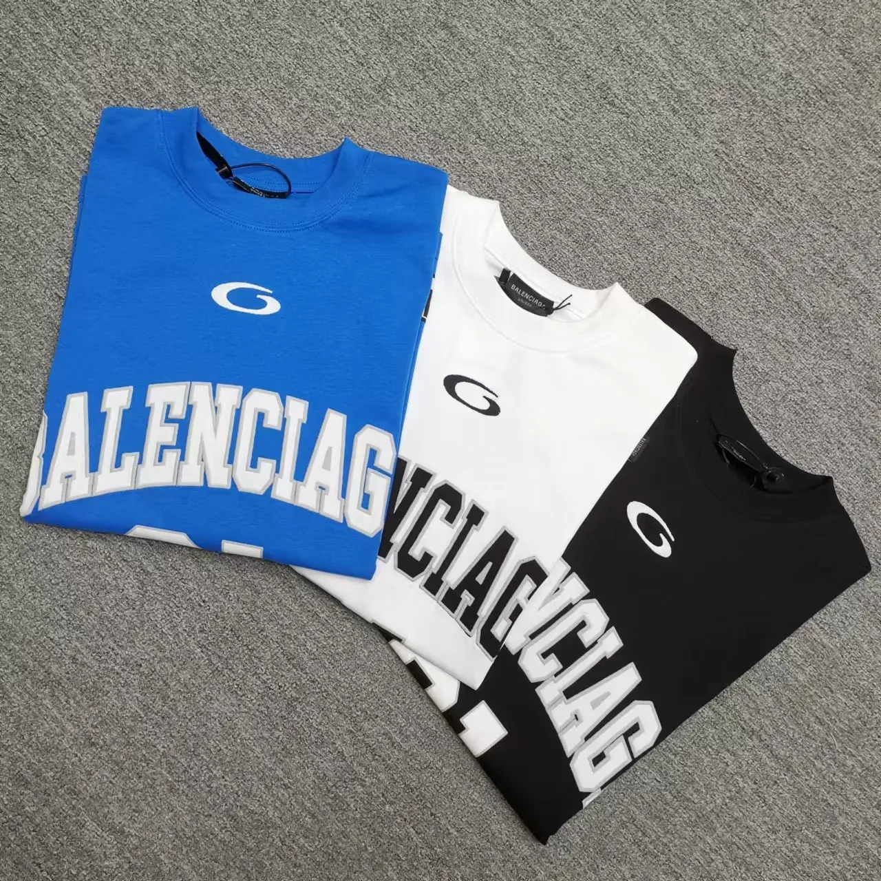Top version Balenciaga SS25 Front letter embroidery Printed round neck short-sleeved T-shirt High weight double yarn pure cotton fabric Loose version Purchase the original pattern and make a sample. Compare the original fabric, version and details. Fabric: 100% cotton fabric is used, and imported cotton yarn is used. Soft, skin-friendly and non-irritating.  Craftsmanship: The clothing is a front-shoulder version, and all pieces are cut one-to-one by professional masters. Details: All accessories are genuine one-to-one custom-made and fully equipped, including the buttons on the front of the clothing.  Purchase the original benchmarking details fabric, high version, heavy weight 320g double yarn pure cotton fabric, color: blue, black, white, code number: XS S M L P: 310