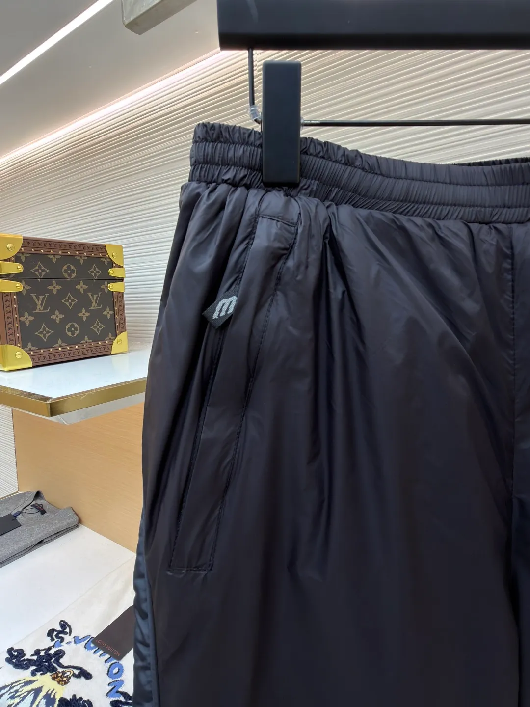 Balenciaga SKIWEAR series 3B printed fleece ski pants ●Original version: purchased and developed by 12414 ●Item number: 1682492-B25 ●Fabric: nylon fabric ●Technology: printing production ●Color: black ●Version: fitted version ●Weight: about 415 grams ●Size: S-M-L-XL ●Description: High-density technological nylon fiber is selected, and a delicate matte texture is created through a special textile process. The black tone presents a low-key and high-end visual effect. The fabric is lightweight yet stiff, has excellent wrinkle resistance and abrasion resistance, and is not prone to pilling or deformation for daily wear. It also has certain windproof properties to cope with changeable weather. The inner lining is made of high-density fluff material with excellent fluffiness and elasticity. When it closely fits the skin, it can form a layer of warm air, effectively locking in heat and improving the warmth factor of winter wear. The down fiber is delicate and smooth, avoiding the rough feeling of traditional plush fabrics, achieving the dual experience of "lightness and no burden" and "constant temperature and warmth", taking into account both comfort and practicality. Imported silicone printing technology is used on both sides of the trouser legs to present the iconic 3B sports icon pattern in a relief-like three-dimensional form. The silicone material has been pressed at high temperature and is tightly integrated with the fabric, making it difficult to fall off and crack. At the same time, it retains a delicate matte luster, forming a subtle texture contrast with the pants fabric, highlighting the brand recognition in a low-key manner. The mid-waist design is equipped with a double-layer elastic rib waistband and a built-in adjustable drawstring. The elastic fiber at the waistband has been pre-shrunk to ensure that it is not easy to loosen after long-term wear. It can not only stabilize the waist shape, but also adapt to the activity needs of different body shapes, taking into account sports functionality and daily comfort. The overall wiring is straight and delicate, the fabric is comfortable and soft, and the color is consistent without color difference. It can be matched with the same style to create a fashionable look and control various occasions. Customized accessories, complete with three standards, same style for men and women!
