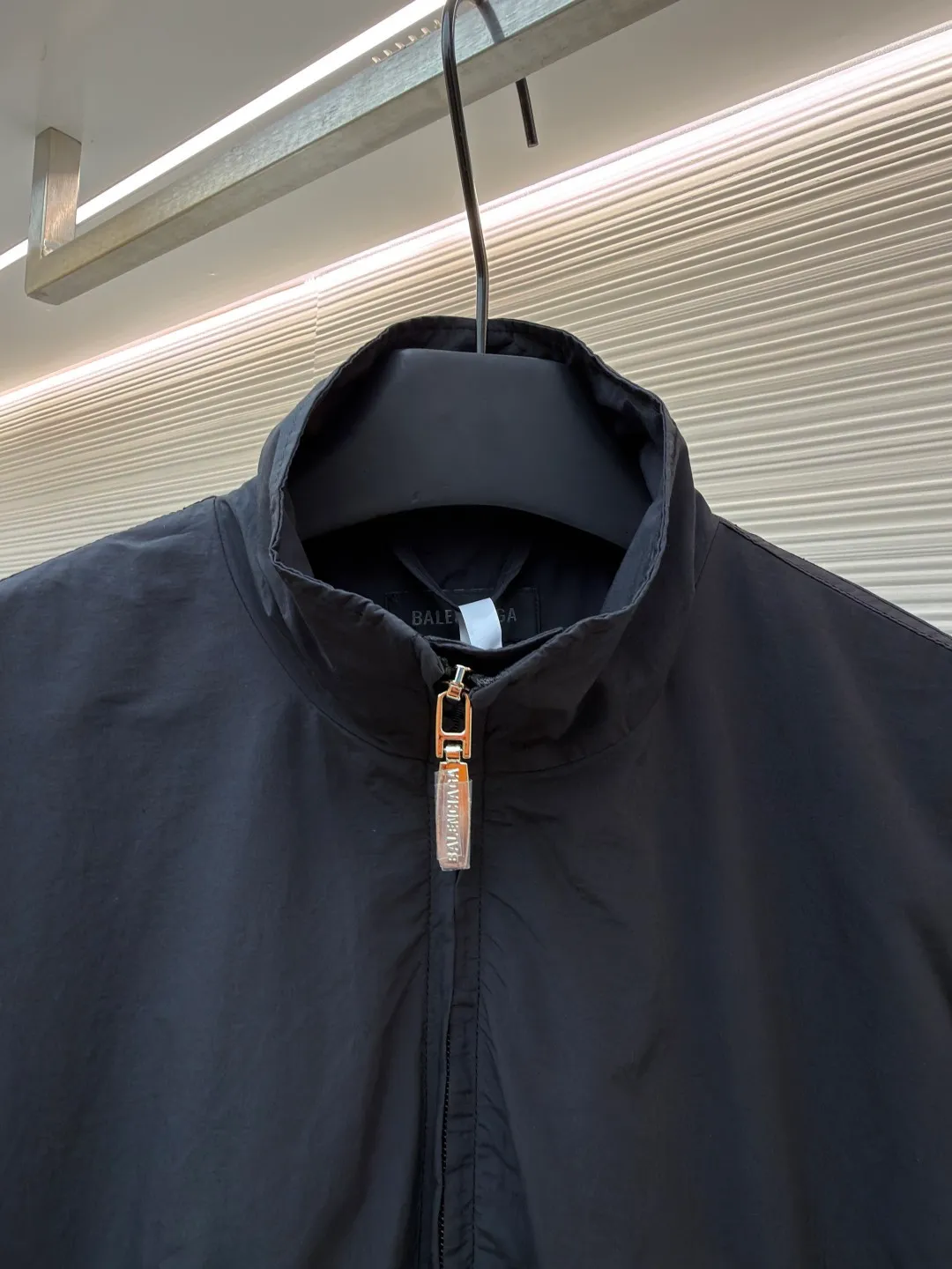 Balenciaga glue print jacket ●Original version: Purchased and developed for 20000 ●Item number: 1682403-B40 ●Fabric: woven nylon fabric ●Technology: glue printing production ●Color: black ●Version: fitted version ●Weight: about 480 grams ●Size: XS-S-M ●Description: This Balenciaga cotton blended jacket is made of 65% cotton and 35% polyester fiber blended fabric. It is first processed by a high-temperature pre-shrinking process to control the fabric shrinkage within 1% to avoid deformation after wearing and washing. The brand logo on the front of the body is made using glue printing technology. Before printing, the fabric is statically eliminated, and then the glue is tightly combined with the fabric through 150℃ high temperature printing. The pattern is clear, does not fall off and is friction-resistant. The jacket adopts a stand-up collar zipper design. The metal zipper has been treated with anti-oxidation plating and is smooth and easy to pull. The cuffs and hem are made of elastic ribbing. The rib weaving method is 1*1 double-needle technology, which is durable and not easy to loosen. The side seam pockets use invisible inlay technology with a stitch density of 8 stitches per centimeter. The shoulders are seamlessly taped. The overall craftsmanship takes into account the brand's iconic simple design and durability, and the details highlight the production standards of high-end clothing. The overall wiring is straight and delicate, the fabric is comfortable and soft, and the color is consistent without color difference. It can be matched with the same style to create a fashionable look and control various occasions. Customized accessories, complete with three standards, same style for men and women!