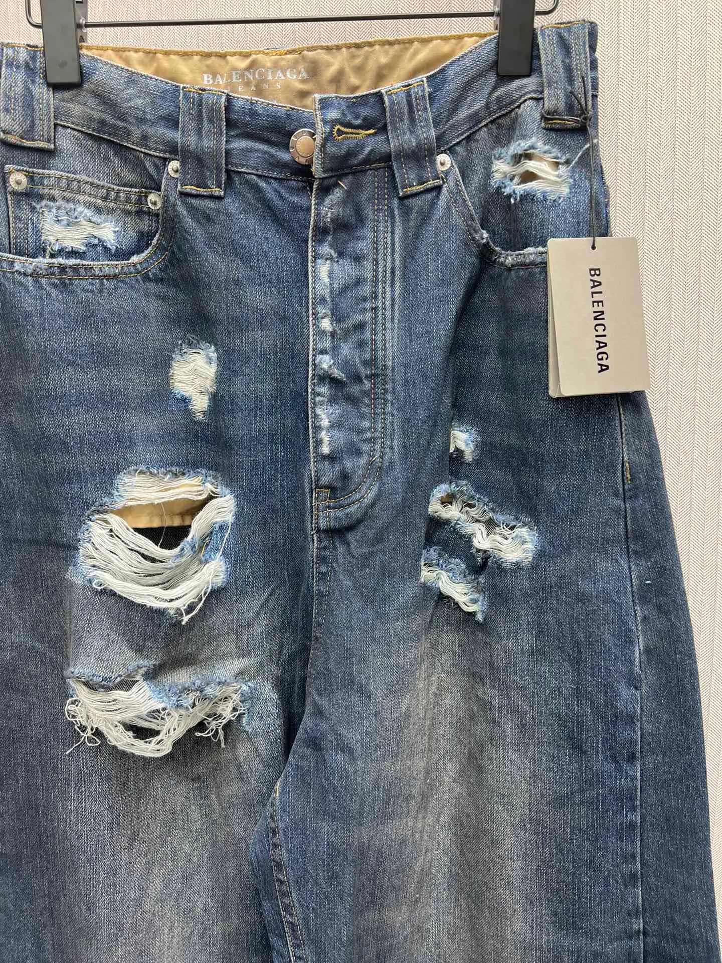 🅿️490 Paris Blcg 25 destroyed denim wide-leg pants. The fabric is made of high-density pure cotton twill denim imported from Italy. The loss of narrow-width fabrics is great to restore the loose and drooping feeling. The fabric is first washed and de-padded. The washing process needs to be repeated 3 times to restore the color. It is washed and sanded to form an aged texture. The color is too natural. Finally, a professional painter is required to spray dirty transitions. Custom-woven and dyed trouser fabrics. Pocket fabrics. The entire thickness. The material is consistent with YB. The cuts are positioned and damaged. Hand-made grinding and hand-picking. A complete set of customized accessories. Bronze hardware with fine flat nails. The details of the mold-opening custom shake-button buckle are synchronized. Mid-rise jeans. Loose jeans. Size: XS.S.M.