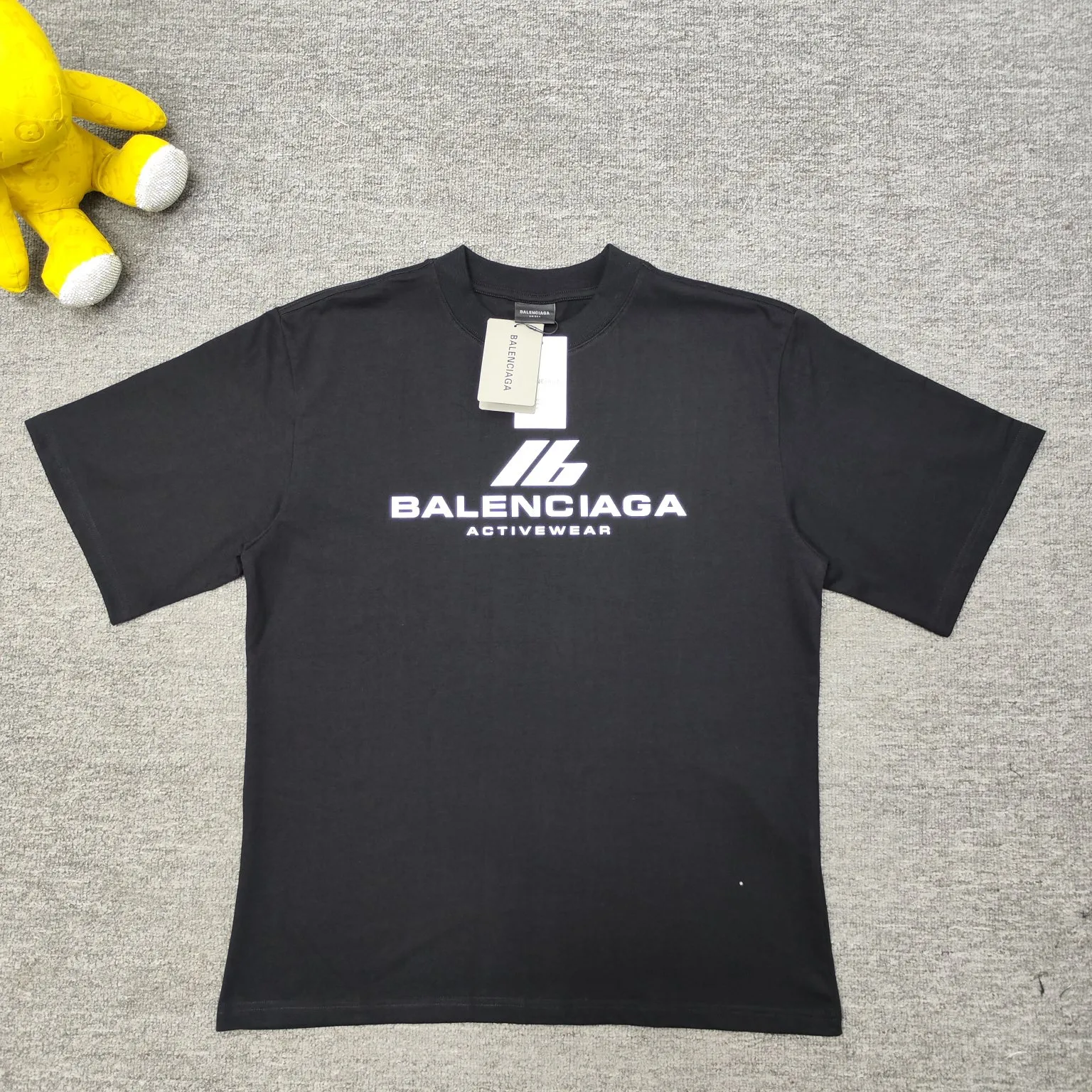 [New] Top version - BALENCIAGA - Reflective heat transfer short-sleeved T-shirt. The original development of customized fabric technology and washing process. High weight 280 grams of fabric. Full texture. Clean cloth. Soft and comfortable. Solona thread custom dyeing without color difference. Activewear logo on the front. Combined with reflective embellishment. Glowing and eye-catching. Fully interpreting strength and personality. Cool and sassy. Reflective heat transfer process Cleverly combining the characteristics of heat transfer and reflective materials, the customized reflective materials are attached to the fabric through heat pressing. The unique reflective effect highlights the visual effect. The fabrics have been washed and have a better hand texture. It is not easy to deform, not easy to shrink and not easy to fade. It maintains long-term beauty. os dropped shoulders and loose version. Same style for men and women. Color: Black Active White Size: XS-L P:270