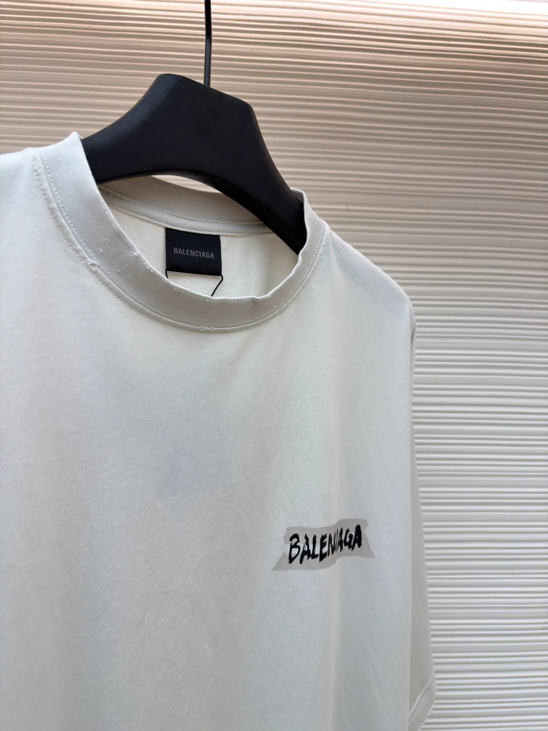 Balenciaga white background glue printed round neck short sleeves ●Original version: purchased and developed for 6500 ●Item number: 1681596-A15 ●Fabric: retro plain knitted fabric ●Technology: Glue printing production ●Color: white ●Version: fitted version ●Weight: about 255g ●Size: Thread, weight is 270g. The weight of the fabric ensures lightness and breathability. The 24-count yarn gives the fabric a delicate and smooth texture, and the plain knitted structure brings good skin-friendliness and moderate elasticity. The fabric has been washed in faded gray, which not only gives it a unique retro look and softens the color, but also achieves a pre-softening effect on the touch, eliminating the stiffness of new fabric and giving the garment a comfortable and soft old material feel when worn for the first time. Dark floral dot multi-layer overlay printing is an advanced printing technology that combines fine patterns and three-dimensional layers. Its core is to use high-mesh dot plate making to overprint transparent or light-colored printing paste on the fabric base multiple times with micron-level precision. Each overlay is accurately aligned to form a faint dark flower texture. The printing pattern does not rely on bright colors, but creates subtle light and shadow gradients and tactile layering on the surface of the fabric through the thickness difference of slurry accumulation and light refraction. The pattern shows subtle changes at different angles, combining visual depth and long-lasting washability. The overall wiring is straight and delicate, the fabric is comfortable and soft, and the color is consistent without color difference. It can be matched with the same style to create a fashionable look and control various occasions. Customized accessories, complete with three standards, same style for men and women!