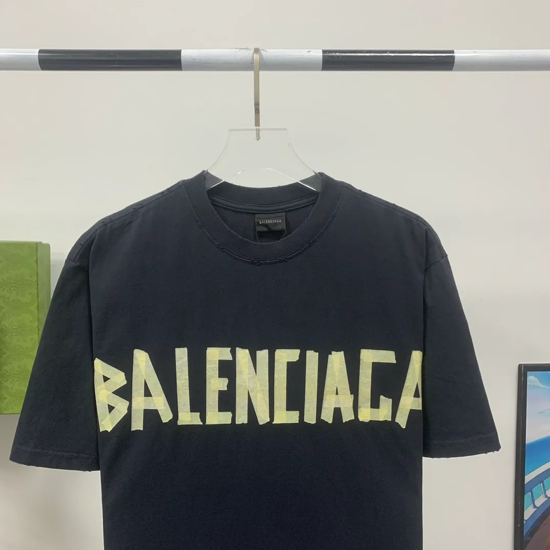 [Breaking new arrival] Top quality BALENCIAGA Paris spring and summer latest tape print washed and worn male and female couple star same style short sleeves 23ss tape tye black retro plain fabric medium version short sleeves Paris' new season's products have added the elements of artistic tape stickers, hot rhinestones and post-it notes, changing the previous minimalist printing style, this time the creativity is really laborious. The micro-OS style is friendly to both men and women. The fixed yarn and washed cotton are soft and waxy and resistant to damage. The slightly distressed worn details are a no-brainer for me who likes 𝐕𝐢𝐧𝐭𝐚𝐠𝐞. There are two styles of front and back printing. The front is like paper tape, and the back is a bright yellow graffiti painting effect, which has a strong impact on people. It looks great with denim overalls, and it’s super cool for girls to wear it with their lower body missing. Original custom-woven and dyed pure cotton material, heavily distressed. Counter 1/1; This product has a unisex design. The same oversize version for men and women·Tape Type logo on the front and back. It is characterized by heavy wear and washable effect. P; 140 Size: XS-L