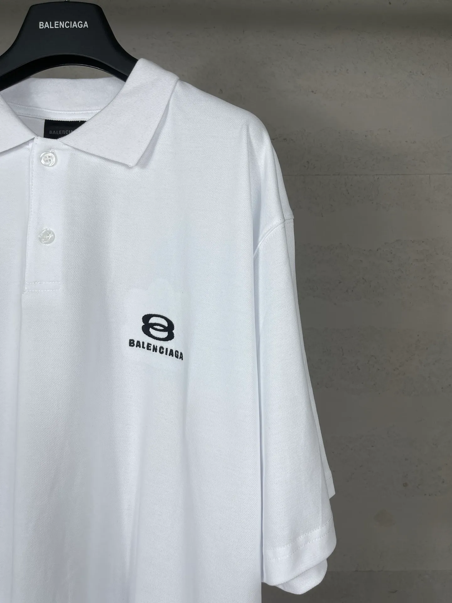 🅿️220 real photos [Top version. Official website quality] BALENCI*GA/Paris #2025 new Paris double-ring classic LOGO embroidered POLO shirt, with front and rear slit design, full of design, welcome to compare. The fabric is made of Paris ZP custom-woven and dyed cotton pique, with a weight of 260 grams. The cloth surface is clean. The cloth pattern is clear, soft and comfortable. The threads are woven and dyed with no color difference. The embroidered LOGO is embroidered using imported Tajima embroidery machine. The effect is three-dimensional. Restore the brick cabinet, adopt OS loose shoulder style. Same style for men and women. Coding: BL252215 Color: black, white Size: XS S M L
