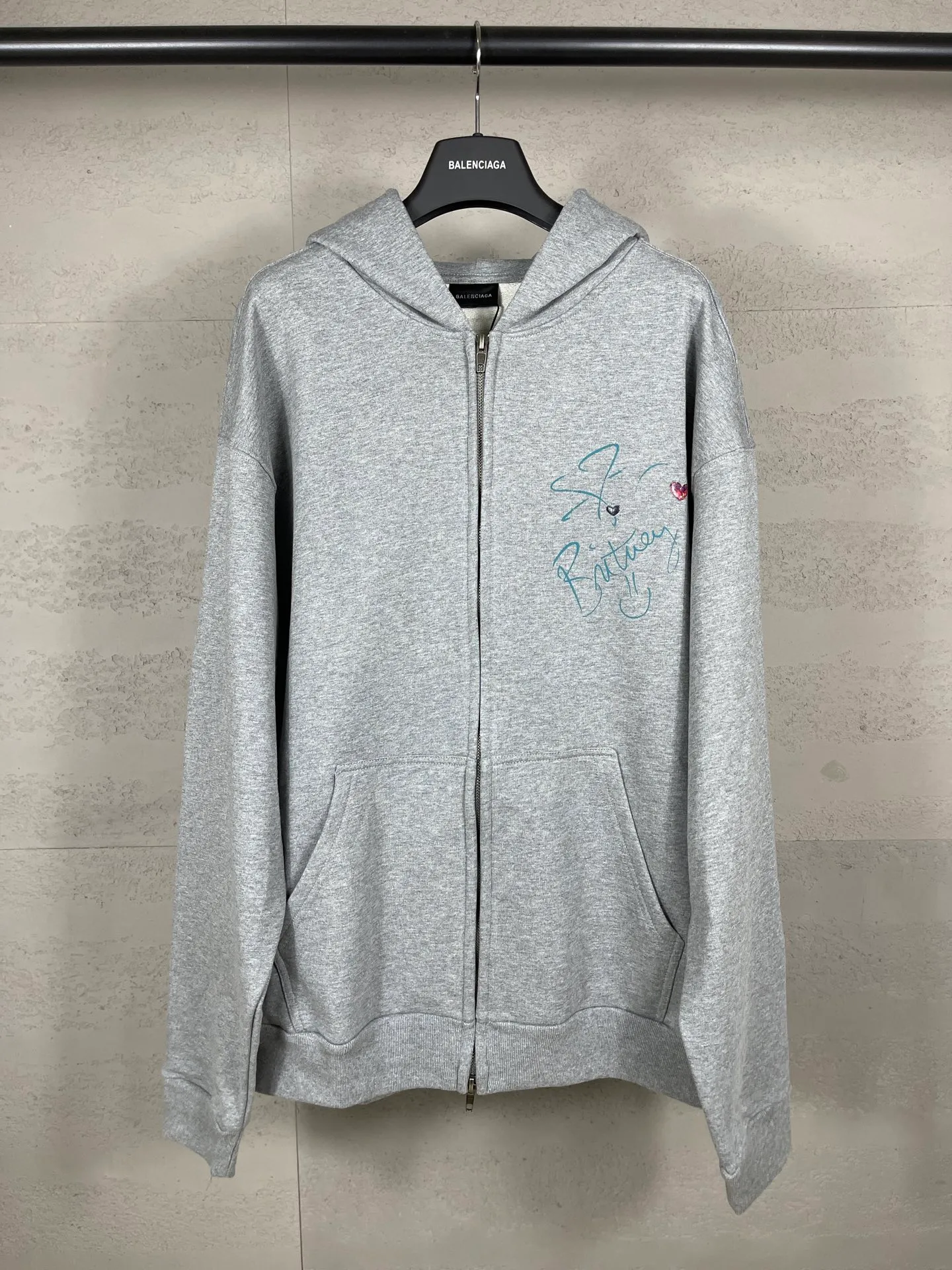 🅿️390 real photos [Top version. Official website quality] BALENCI*GA/26 new model. Balenciaga Music |Britney Series limited edition music collaboration series, front and back direct-print printing, embroidered hat, zipper hooded cardigan and sweatshirt, SS26 latest style. Research and development at the first time, different market currencies. Comparisons welcome. The fabric is made of Paris ZP custom-woven and dyed cotton sweatshirt, with a weight of 460 grams. The cloth surface is clean. The cloth pattern is clear, soft and comfortable. The threads are dyed with no color difference. Printing adopts computer direct printing. The embroidery is done using imported Tajima embroidery machines. Jubie market currency. Welcome to compare. The version adopts OS loose shoulder design. Same style for men and women. Code: BL259958 Color: Gray Size: XS S M L