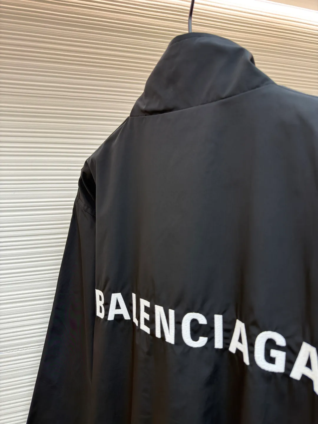 Balenciaga stand collar logo embroidered quick-drying jacket ●Original version: purchased and developed by 10128 ●Item number: 1681403-B40 ●Fabric: Satin blended fabric ●Technology: embroidery production ●Color: black ●Version: Loose fit ●Weight: about 380 grams ●Size: 36-38-40-42 ●Description: This jacket is made of high-quality windproof fabric, with a crisp texture and good breathability. The stand-up collar design fits the neck and is windproof and neat. The brand letters on the back adopt three-dimensional embroidery technology, the stitches are even and full, and the letter shape is three-dimensional and layered, making it highly recognizable. The body is cut in a loose fit with smooth and natural lines, making it comfortable and casual to wear. The ribbed design on the cuffs and hem has excellent elasticity, fits the body shape, and is windproof and warm. The zipper is smooth and durable, and harmonizes with the overall style. From fabric selection to embroidery craftsmanship to rib processing in details, every step reflects the brand's rigorous control of craftsmanship, not only showing a sense of street fashion, but also ensuring practicality and quality through exquisite craftsmanship. The overall wiring is straight and delicate, the fabric is comfortable and soft, and the color is consistent without color difference. It can be matched with the same style to create a fashionable look, and can be used in various occasions. Customized accessories, complete with three standards, the same style for men and women.