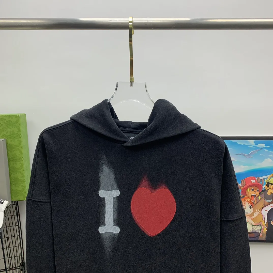 The top tried and tested version of BALENCIAGA's love ❤️printed male and female couple star's same style pullover hoodie sweatshirt. Decorated with I ❤️art work embroidery on the front｜brand logo embroidery on the lower back｜distressed effect. Heavy 480g pure cotton terry fabric, full of feel. The weight of the ready-made clothes is more than one kilogram, and the drape is very good! The new plate-making process that imitates hand embroidery has the rough feel of hand embroidery, and the stitching method is adjusted according to the original pattern. After embroidery, the stitching technique is imitated by hand embroidery, and the smooth curves highlight the embroidery effect.  The main body of the logo pattern is precision stitched; the embroidery is very fine and dense. Linen embroidery thread is used combined with dense processing to increase the three-dimensional effect, and the embroidery body has a subtle matte visual texture. Color: washed black white Size: S--XL P:390