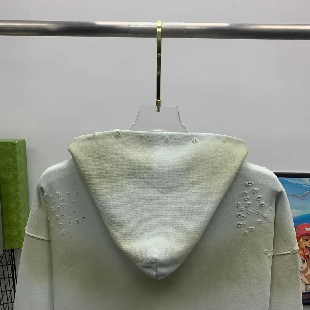 Top tested version 23FW BALENCIAGA Paris Manchester United limited edition distressed male and female couple star same style pure cotton loose hooded sweatshirt [very suitable for Douyin, and other platforms! The letters in the LOGO position have been damaged and polished! 】 The fabric is custom-made washed knitted cotton terry material. The upper body is very soft. The front panel uses a classic hand pocket with a worn effect. The overall yellow and dirty effect is all artificially sprayed with majolica. It requires proficiency and experience to achieve this natural and elegant effect!  Customized towel embroidery on the chest, heavily damaged! The aging effect is very obvious! The overall artificial positioning coating is hand-made, washed and dirty. The frayed hole craftsmanship has a hand-painted graffiti effect. The arms behind the bend are made of open-stitch frayed craftsmanship. The wiring is delicate. Elastic cuff design. The whole body is hand-positioned with muddy dyeing and frayed effect! Ready-made garments are washed twice with water +➕ once with wax. It feels smooth!   The Manchester United letters and logo on the chest are designed with full embroidery and the details are visible!  Size: XS-L Color: White Black P: 470