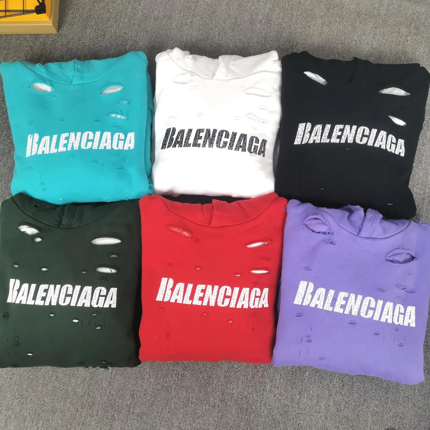 The top tested version of BALENCIAGA's Basic Cracked Sweatshirts and Hoodies for Male and Female Couples Stars can be said to be the most popular item among all the popular items. It has become popular on major self-media e-commerce platforms such as Xiaohongshu and Dewu. Heavy industrial craftsmanship tests the skills of lathes and printing techniques. Huge cost! Fabric: The outer fabric is made of 460g pure cotton fish scale terry fabric + the inner liner is 260g combed cotton. The weight of the ready-made garment exceeds 1kg, which can ❗️100%❗️ restore the drape of zp. The cost of fabric is over one hundred yuan. Washing process: After making the garment, the holes are polished by hand, and then washed to make it look old. The process is extremely complicated! There are more than 200 holes in the entire dress. The collar, cuffs, and hem are torn by hand (with pliers) rather than frayed. This is a more important detail.  Thread: dyed in the same vat with no color difference. Printing: made of special cracked material to achieve the ultimate in breathability and aesthetics! Just like the patterns on a turtle’s back, each one is different!  Accessories: Complete set of customized accessories + Sydney paper Size: XS-L (maximum wear: 230 catties) Color: blue black white purple red cyan P: 570