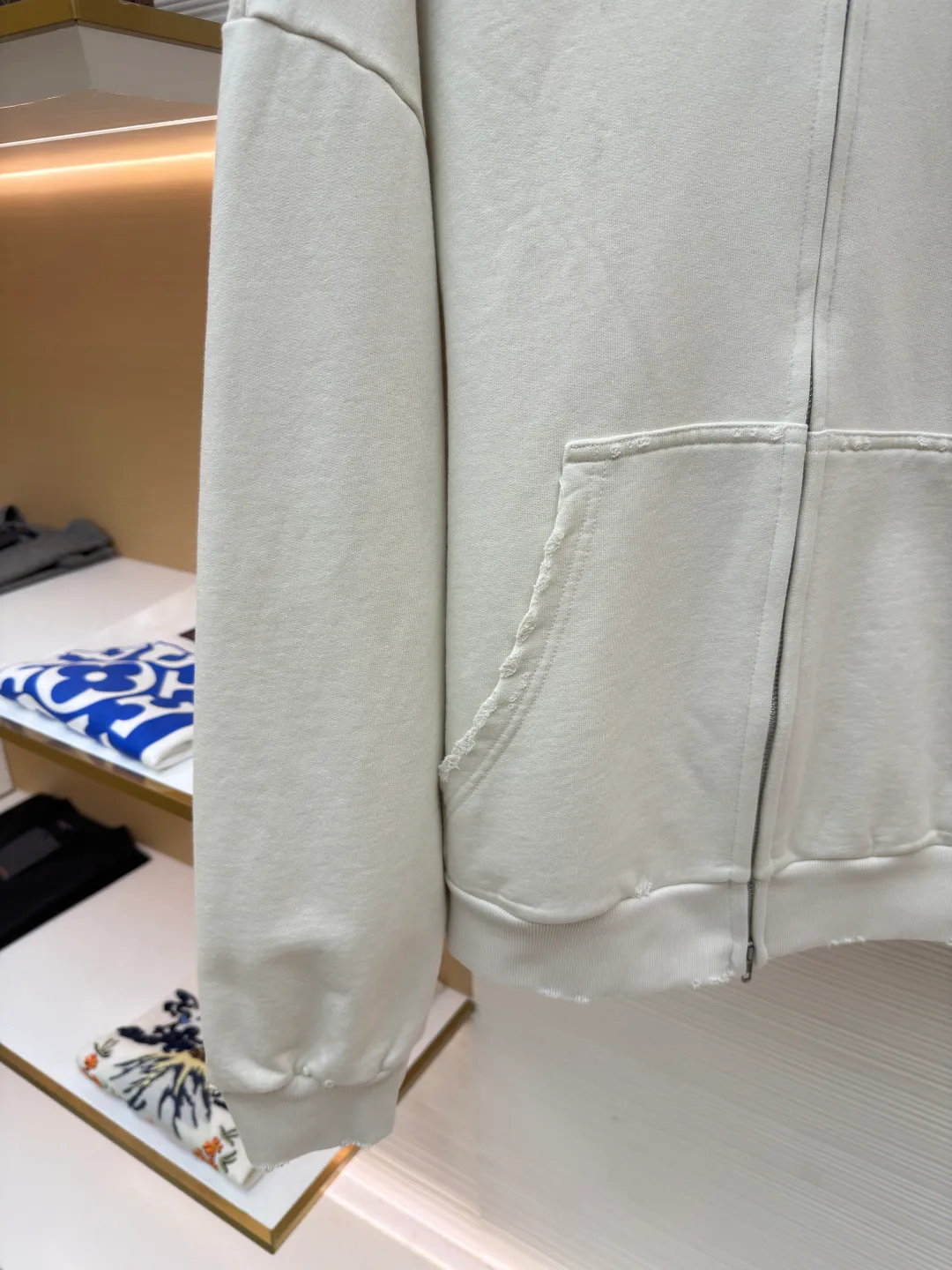 Balenciaga letter embroidered hooded zipper long-sleeved sweatshirt ●Original version: Purchased and developed for 9200 ●Item number: 1682263-A95 ●Fabric: combed cotton ●Technology: Washed and frayed ●Color: white ●Version: loose fit ●Weight: about 965 grams ●Size: S-M-L ●Description: This Balenciaga letter embroidered hooded zipper sweatshirt is made of 380g heavyweight pure cotton terry cloth, which has been treated with enzyme washing process. The fabric has a natural old-fashioned soft and waxy texture. At the same time, the stone grinding process is used to create irregular raw edge effects on the cuffs and hem, restoring the retro street style. The body adopts a loose, dropped-shoulder version, and the three-dimensional tailoring makes the shoulder lines smooth. The hooded part has a built-in drawstring made of pure cotton and is pre-shrunk to prevent it from deforming. The custom-made metal zipper on the front zipper closes smoothly and has no lag after repeated opening and closing tests. The brand letters on the left chest are made with imported embroidery machines using flat embroidery stitches, using polyester thread with high color fastness. The stitches are fine and neat without skipping, and the letter outline is three-dimensional and clear. The overall stitching uses double-needle overlocking technology, with up to 12 stitches per inch. The ribbed edges on the cuffs and hem are made of spandex blended material, which has long-lasting elasticity and is not easy to loosen, taking into account both wearing comfort and stiffness. The overall wiring is straight and delicate, the fabric is comfortable and soft, and the color is consistent without color difference. It can be matched with the same style to create a fashionable look and control various occasions. Customized accessories, complete with three standards, same style for men and women!