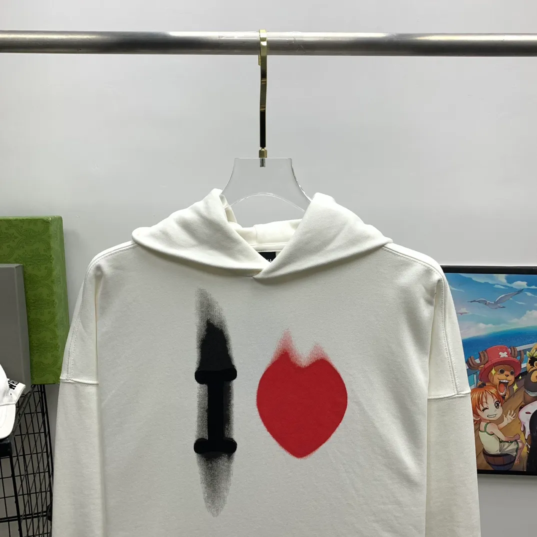 The top tried and tested version of BALENCIAGA's love ❤️printed male and female couple star's same style pullover hoodie sweatshirt. Decorated with I ❤️art work embroidery on the front｜brand logo embroidery on the lower back｜distressed effect. Heavy 480g pure cotton terry fabric, full of feel. The weight of the ready-made clothes is more than one kilogram, and the drape is very good! The new plate-making process that imitates hand embroidery has the rough feel of hand embroidery, and the stitching method is adjusted according to the original pattern. After embroidery, the stitching technique is imitated by hand embroidery, and the smooth curves highlight the embroidery effect.  The main body of the logo pattern is precision stitched; the embroidery is very fine and dense. Linen embroidery thread is used combined with dense processing to increase the three-dimensional effect, and the embroidery body has a subtle matte visual texture. Color: washed black white Size: S--XL P:390