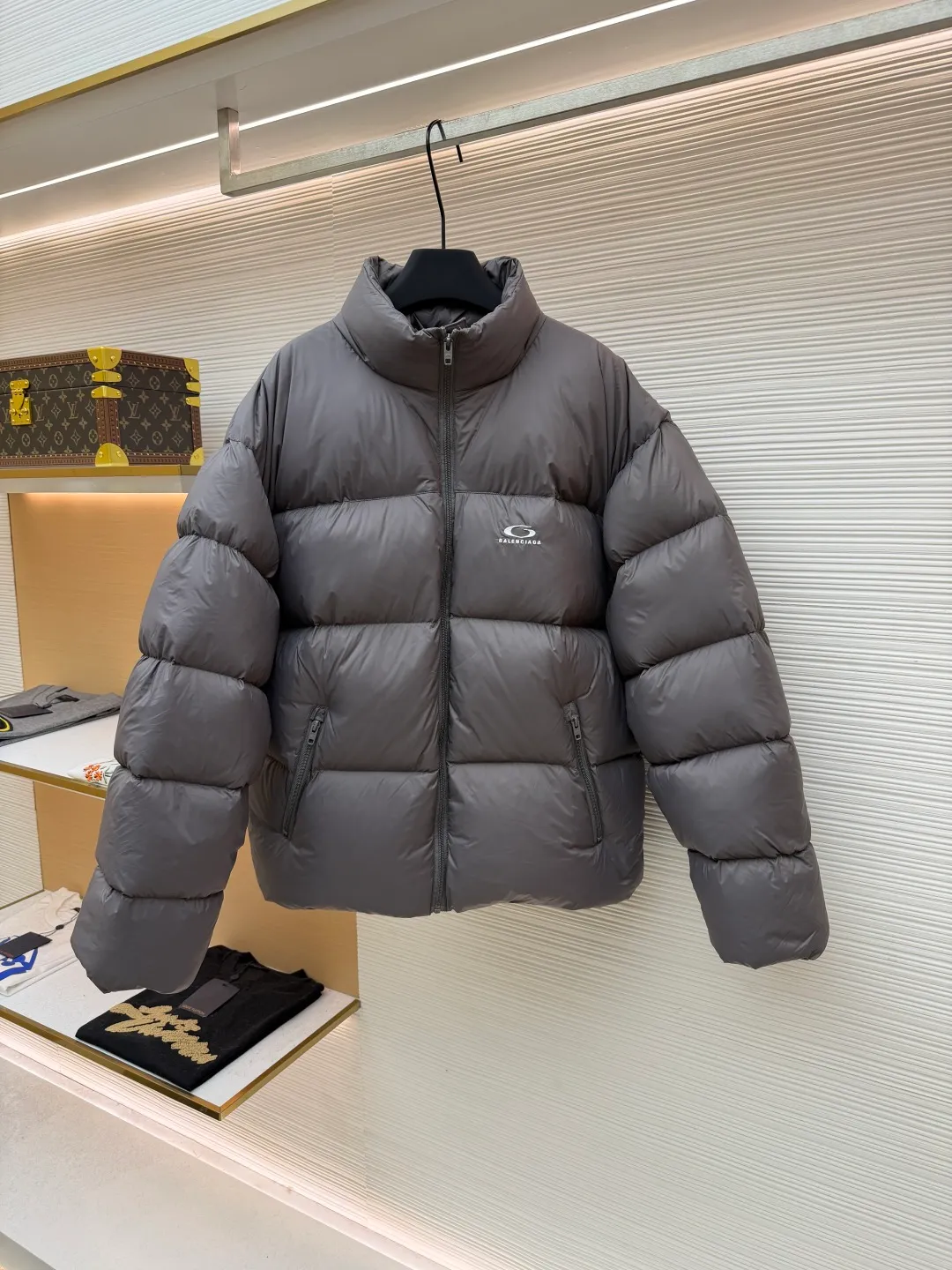 Balenciaga single-loop embroidery down jacket ●Original version: Purchased and developed by 12336 ●Item number: 1681876-D15 ●Fabric: white duck down fabric ●Technology: mechanical down filling ●Color: gray ●Version: loose version ●Weight: about 750 grams ●Size: S-M-L-XL ●Description: Custom-developed high-count and high-density woven fabric is the cornerstone of its high-end texture. High count means that the yarns are extremely fine, resulting in a finely textured and silky-touch surface; high density gives the fabric excellent stiffness, abrasion resistance and wind resistance. It avoids the rough feeling of ordinary cotton canvas and presents a low-key and precise micro-gloss, which provides a perfect and stable foundation for subsequent embroidery and hemming processes. The filling process needs to ensure that the cotton body is evenly distributed within the quilting grid without holes or agglomerations, which requires extremely high filling accuracy. The hemming is like the steel frame of a building, which strengthens the overall silhouette of the vest and makes the lines sharper and clearer, reflecting the brand's meticulous attitude towards tailoring. Dense embroidery on this thin and dense fabric can easily cause the fabric to shrink and deform. The brand will use special water-soluble lining or hot-melt lining on the bottom layer of embroidery. These linings will disappear after the embroidery is completed, ensuring that the pattern is smooth and crisp without destroying the flexibility of the fabric itself. This is the ultimate test of the combination of handicrafts and technology. The overall wiring is straight and delicate, the fabric is comfortable and soft, and the color is consistent without color difference. It can be matched with the same style to create a fashionable look and control various occasions. Customized accessories, complete with three standards, same style for men and women!