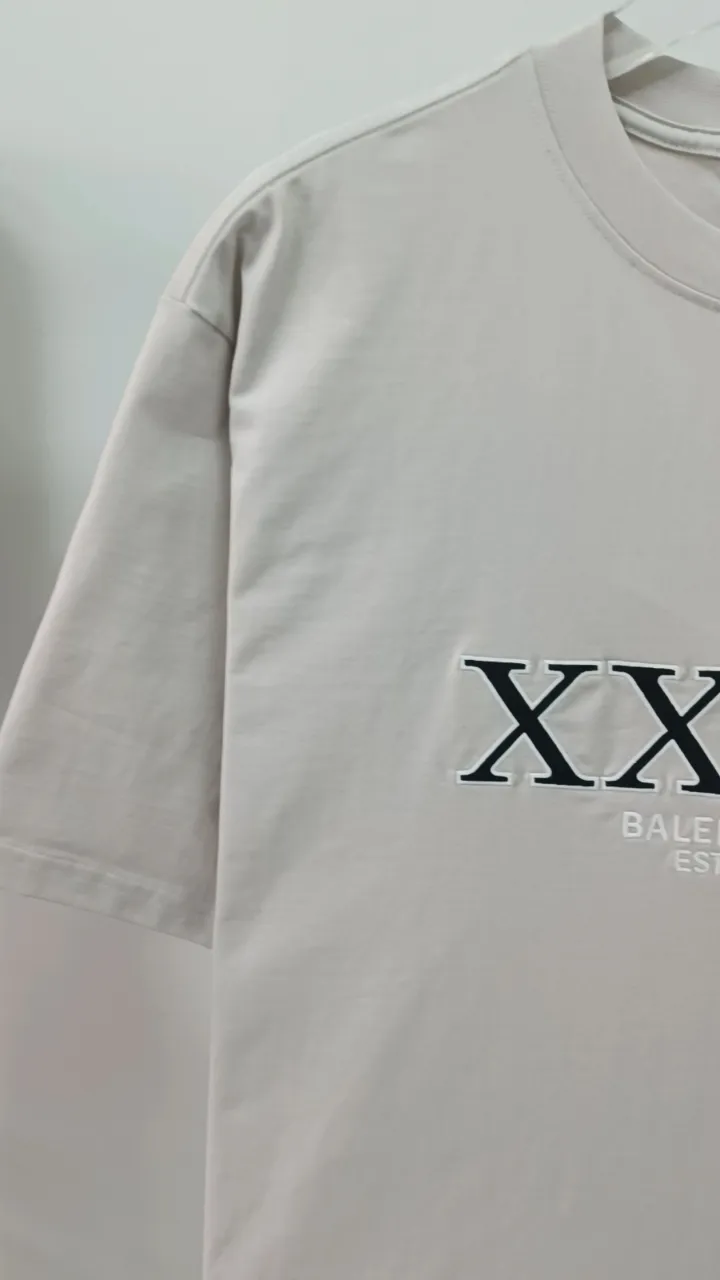 Frontal real-shot video————The top tested version of Balenciaga BALENCIAGA’s new XXXL letter embroidery, milky white latest style bottoming short-sleeved T-shirt [new ceiling level] - 2023 new version shipped! Feel free to compare top quality products!  -Using imported Tajima 10w needle machine embroidery, high-density embroidery letter wrapping technology, full details and no tails, clear letters without connections‼ ️ - BLCG's latest fashion series, Jay Chou's same upper body, new models are released every year, milk white color is new this year, I didn't hesitate to buy it as soon as I saw it, the upper body is whiter, I love this color so much! The new customized fruit pattern collar label is different from the previous embroidered LOGO collar label, please pay attention to the distinction! -Full set of 1:1 customized accessories + Sydney paper with logo + new version of handbags at the counter + three labels for large products + original hangtag -The webbing on the back collar extends to the shoulders for reinforcement, and the stitches are downturned at the joints. Imported elliptical machine with imported glue technology. Overall printing without teeth. 32s280g double yarn combed cotton fabric, weighing up to 400 grams after washing!  Color: Washed Black Apricot Size: XS-L P:310