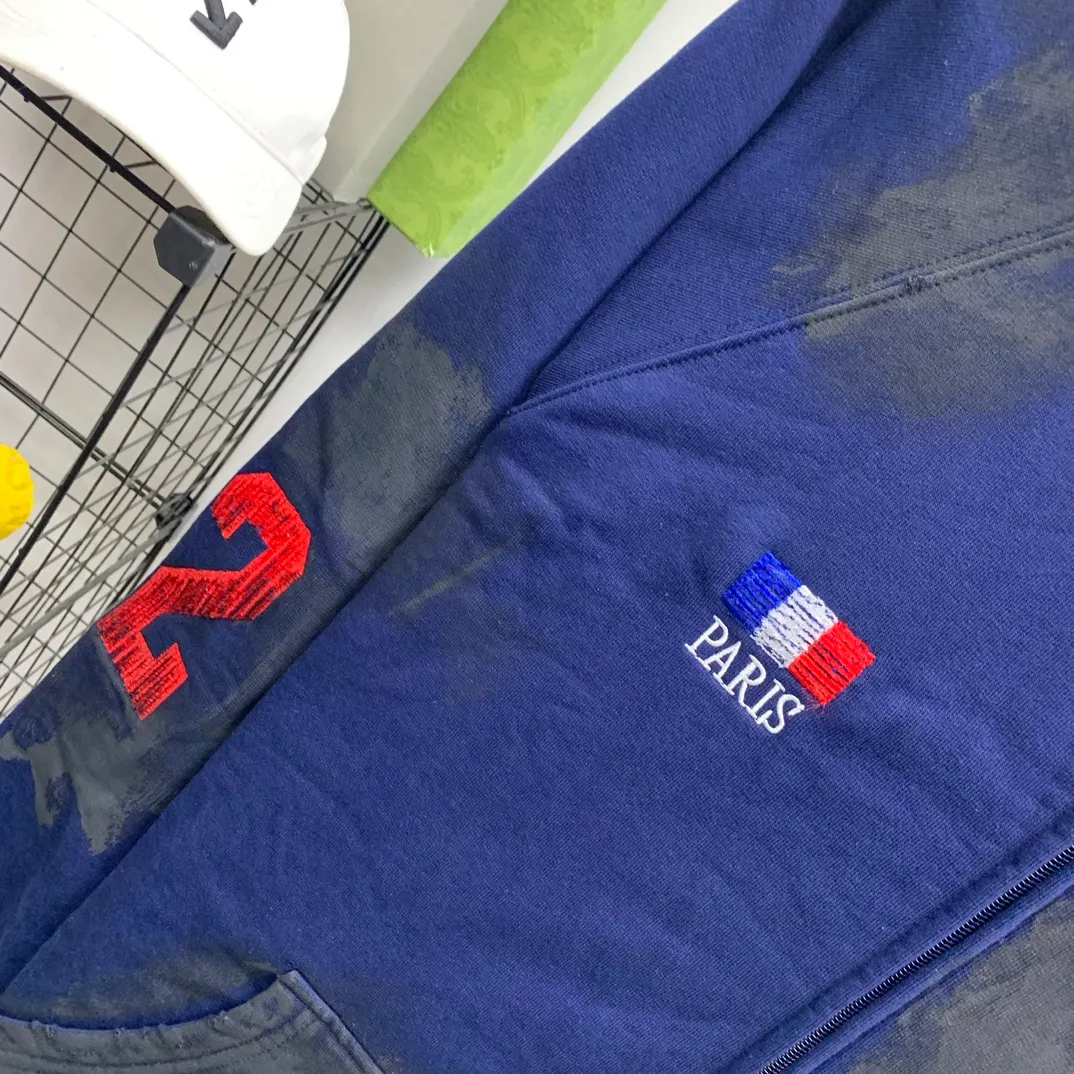 Top tested version Balenciaga Paris co-branded Lauren Raff mustang war horse embroidered flag muddy old dirty zipper cardigan sweatshirt #custom-woven Paris fabric 480g. The zipper is matched with a custom logo. Imported Tajima machines are used to embroider large-area heavy-duty high-density embroidery effects to make the embroidery more three-dimensional. The back is printed with imported glue. The ready-made garments are hand-ground and irregularly applied with mud to create a mud effect. Each piece of clothing needs to be coated three times, with an hour's interval between each coat to allow the coating to dry completely to ensure that the printing will not stick together. Exclusive and high quality due to heavy work and time consuming labor.   Color: Dark Blue Size: XS-L P:510