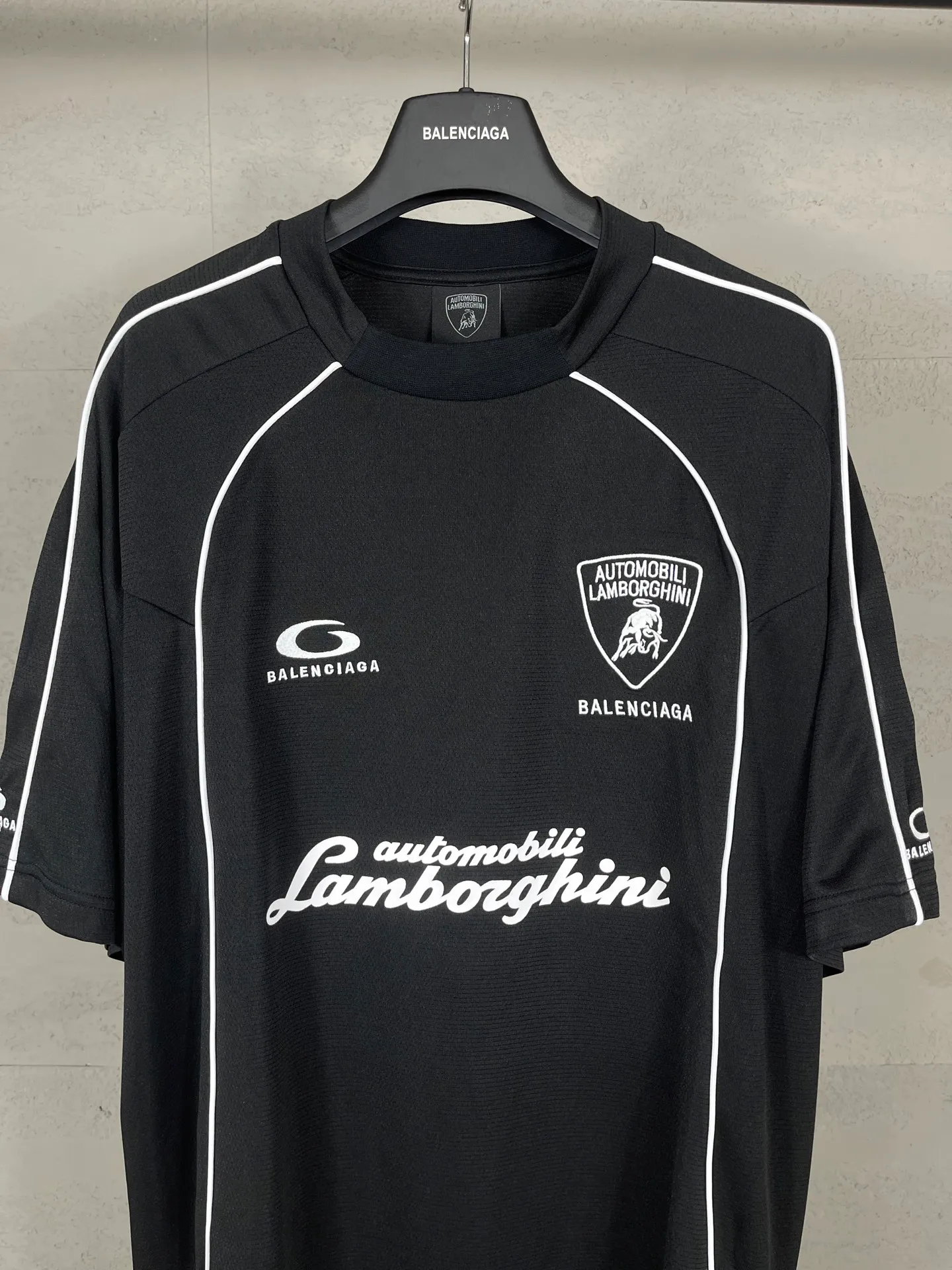 🅿️226 Actual pictures [Top version. Official website quality] BALENCI*GA/Paris co-branded Lamborghini jersey, printed embroidery on the front and back, embroidered on the left and right sleeves, multi-position short-sleeved T-shirt #overweight craftsmanship. SS25 latest model. Research and development at the first time, different market currencies. Comparisons welcome. The fabric is made of custom-woven sports fabric that absorbs moisture and is comfortable and dry. Whether you are doing sports or fitness or going out on the street every day, you can easily become the center of attention. Stretch ribbing at neckline. Weighing 260 grams, the cloth surface is clean. The cloth pattern is clear, soft and comfortable. The threads are dyed with no color difference. The printing uses imported environmentally friendly rubber paddles. The embroidery is done using imported Tajima embroidery machines. The pattern letters are clear, three-dimensional and without burrs. Jubie market produces pictures based on pictures. Welcome to compare. The version adopts OS loose shoulder design. Same style for men and women. Code: BL253691 Color: black, white Size: XS S M L
