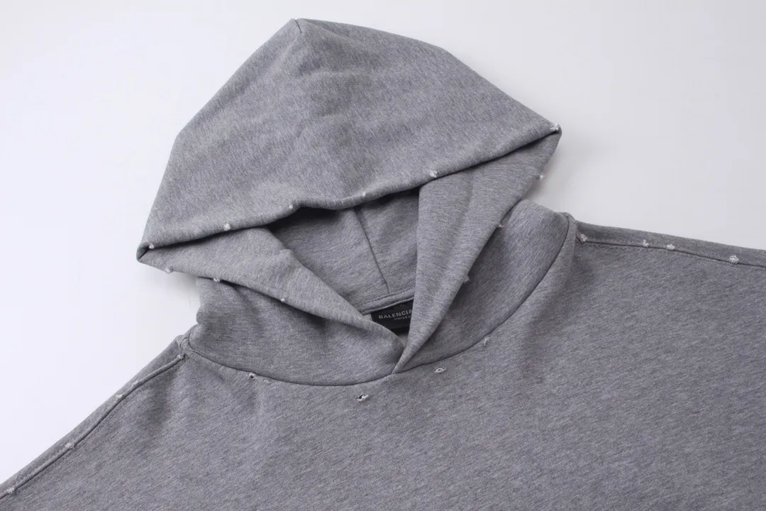 🅿️330 detailed pictures [Top version. Official website quality] BALENCI*GA/Paris BALENCI*GA#2024 latest model, classic letter LOGO graffiti. Toothbrush embroidery ready-to-wear distressed hooded sweatshirt. Brick cabinet synchronization. Genuine products are developed and developed in the first time. Welcome to compare! The fabric is made of Paris ZP custom-woven and dyed cotton sweatshirt. The weight is 450 grams. The cloth surface is clean. The cloth pattern is clear. It is soft and comfortable. It has good color fastness and is not easy to change color. The threads are woven and dyed with no color difference. The embroidery is done using imported Tajima embroidery machines. Over 10W needlework and extremely complex craftsmanship. The effect is three-dimensional and the lines are clear. No rough edges and lines. Ultra-high-tech embroidery. The hand-painted worn-out effect of ready-made garments. The version adopts OS loose shoulder design. Same style for men and women. Code: BL238030 Color: Dark blue gray. Floral gray. Washed blue Size: XS S M L