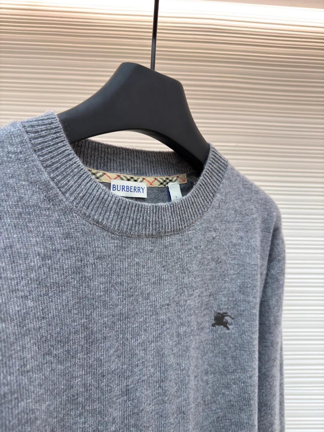 Burberry embroidered crew neck sweater ●Original version: Purchased and developed by 3631 ●Item number: 1681779-B25 ●Fabric: wool blended fabric ●Technology: Knitted production ●Color: gray ●Version: Fitted version ●Weight: about 455 grams ●Size: S-M-L-XL ●Description: Cashmere is the main material that dominates the feel, warmth and lightness of the fabric, while providing an unparalleled wearing experience. A small amount of polyamide and Lycra are added to enhance the overall durability and pilling resistance. An invisible support network is woven into the soft cashmere, and it also has a certain amount of elasticity to better fit the curves of the human body and allow it to be retracted and retracted freely. The ribbed decorative parts of the collar and cuffs are made of blended fabrics of the same proportion, which further enhances the texture and wearing experience. Due to the characteristics of the sweater fabric, it is stretched just right when stretching the frame, and then a hot-melt liner is used under the wool fabric piece to provide it with a certain temporary stable support to prevent it from shrinking after removal, causing pattern distortion, wrinkles and stitch dents. The high-precision calculation program system of the computer embroidery machine controls the movement of the embroidery frame in the X/Y direction, while the needle shuttles up and down, embroidering according to the set path, automatically completing thread trimming, thread jumping and other actions to form a stitch track, automatically adjusting the upper and lower thread tension to ensure that the stitches are smooth and free of floating threads, forming a war horse pattern with an error of ±0.1mm. Add detergent and preliminarily rinse the bulk goods at a water temperature of about 35 degrees to remove impurities during the production process, and then use protease to gently digest the hairiness on the surface to reduce the tendency of pilling from the root, improve the hand feel, retain softness, and eliminate irritation. Finally, after dehydration and drying, the dimensional and shape stability is improved. The overall wiring is straight and delicate, the fabric is comfortable and soft, and the color is consistent without color difference. It can be matched with the same style to create a fashionable look and control various occasions. Customized accessories, complete with three standards, same style for men and women!