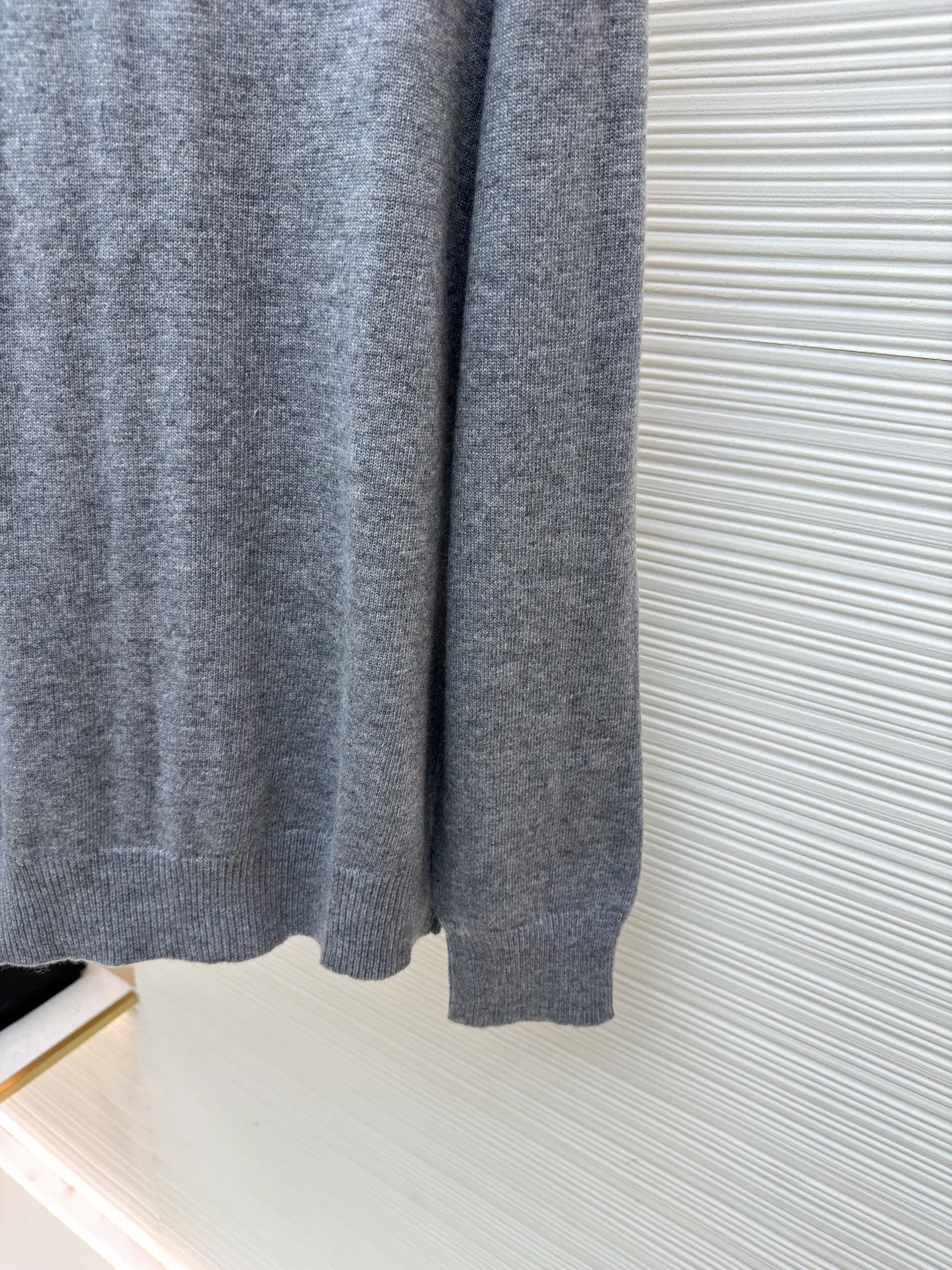 Burberry embroidered crew neck sweater ●Original version: Purchased and developed by 3631 ●Item number: 1681779-B25 ●Fabric: wool blended fabric ●Technology: Knitted production ●Color: gray ●Version: Fitted version ●Weight: about 455 grams ●Size: S-M-L-XL ●Description: Cashmere is the main material that dominates the feel, warmth and lightness of the fabric, while providing an unparalleled wearing experience. A small amount of polyamide and Lycra are added to enhance the overall durability and pilling resistance. An invisible support network is woven into the soft cashmere, and it also has a certain amount of elasticity to better fit the curves of the human body and allow it to be retracted and retracted freely. The ribbed decorative parts of the collar and cuffs are made of blended fabrics of the same proportion, which further enhances the texture and wearing experience. Due to the characteristics of the sweater fabric, it is stretched just right when stretching the frame, and then a hot-melt liner is used under the wool fabric piece to provide it with a certain temporary stable support to prevent it from shrinking after removal, causing pattern distortion, wrinkles and stitch dents. The high-precision calculation program system of the computer embroidery machine controls the movement of the embroidery frame in the X/Y direction, while the needle shuttles up and down, embroidering according to the set path, automatically completing thread trimming, thread jumping and other actions to form a stitch track, automatically adjusting the upper and lower thread tension to ensure that the stitches are smooth and free of floating threads, forming a war horse pattern with an error of ±0.1mm. Add detergent and preliminarily rinse the bulk goods at a water temperature of about 35 degrees to remove impurities during the production process, and then use protease to gently digest the hairiness on the surface to reduce the tendency of pilling from the root, improve the hand feel, retain softness, and eliminate irritation. Finally, after dehydration and drying, the dimensional and shape stability is improved. The overall wiring is straight and delicate, the fabric is comfortable and soft, and the color is consistent without color difference. It can be matched with the same style to create a fashionable look and control various occasions. Customized accessories, complete with three standards, same style for men and women!