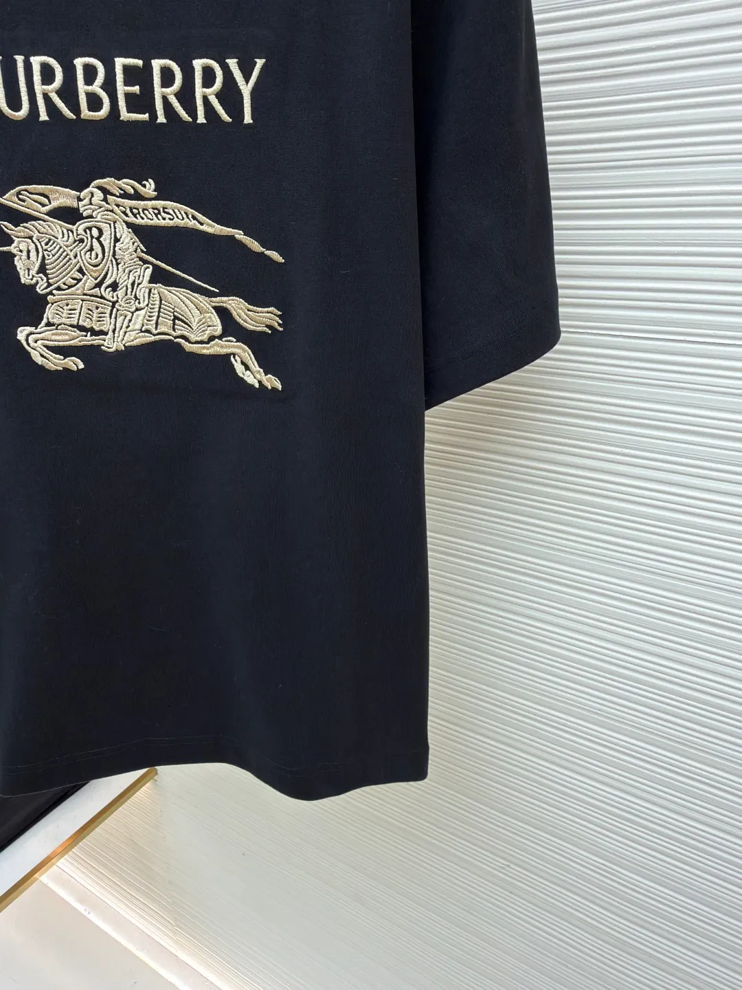 Burberry Thin Line War Horse Embroidery Round Neck Short Sleeve ●Original version: 3250 purchase and development ●Item number: 1681452-X85 ●Fabric: pure cotton fabric ●Technology: embroidery production ●Color: black ●Version: fitted version ●Weight: about 360 grams ●Size: S-M-L-XL ●Description: This T-shirt is made of high-quality pure cotton fabric, which is skin-friendly and breathable. Black and off-white tones are classic and versatile. The brand knight logo on the front adopts precision embroidery technology. The silk thread is rich in color, the stitching is delicate and three-dimensional, and the pattern is rich in layers, highlighting the high brand recognition. The round neck structure is processed by overlocking technology, and the neckline fits the neck and is not easily deformed. The body of the garment is sewn using industrial-grade flat stitching technology. The stitches are smooth and even, and the stitches at the hem and cuffs are fine and firm. From the selection of pure cotton fabrics to the control of embroidery details, every process reflects Burberry's pursuit of craft precision and classic style. It not only retains the daily practicality of the T-shirt, but also demonstrates the brand's light luxury recognition through exquisite embroidery. It is a fusion of casual style and exquisite craftsmanship. The overall wiring is straight and delicate, the fabric is comfortable and soft, and the color is consistent without color difference. It can be matched with the same style to create a fashionable look and control various occasions. Customized accessories, complete with three standards, same style for men and women!