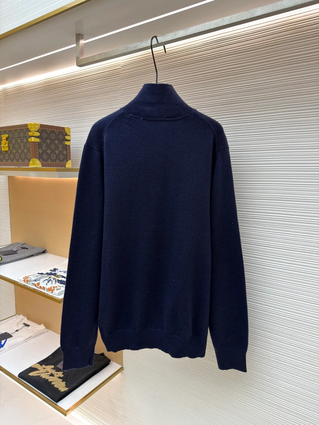 Burberry embroidered half-zip turtleneck sweater ●Original version: Purchased and developed by 4472 ●Item number: 1681783-B25 ●Material: wool blended fabric ●Technology: knitted production ●Color: navy ●Version: Fitted version ●Weight: about 545 grams ●Size: S-M-L-XL ●Description: Cashmere is used as the main body to dominate the feel, warmth and lightness of the fabric, while providing an unparalleled wearing experience. A small amount of polyamide and Lycra are added to enhance the overall durability and pilling resistance. An invisible support network is woven into the soft cashmere, and it also has a certain amount of elasticity to better fit the curves of the human body and allow it to be retracted and retracted freely. Due to the characteristics of the sweater fabric, it is stretched just right when stretching the frame, and then a hot-melt liner is used under the wool fabric piece to provide it with a certain temporary stable support to prevent it from shrinking after removal, causing pattern distortion, wrinkles and stitch dents. The high-precision calculation program system of the computer embroidery machine controls the movement of the embroidery frame in the X/Y direction, while the needle shuttles up and down, embroidering according to the set path, automatically completing thread trimming, thread jumping and other actions to form a stitch track, automatically adjusting the upper and lower thread tension to ensure that the stitches are smooth and free of floating threads, forming a war horse pattern with an error of ±0.1mm. Add detergent and preliminarily rinse the bulk goods at a water temperature of about 35 degrees to remove impurities during the production process, and then use protease to gently digest the hairiness on the surface to reduce the tendency of pilling from the root, improve the hand feel, retain softness, and eliminate irritation. After the final dehydration and drying process, the overall wiring is straight and delicate, the fabric is comfortable and soft, and the color is consistent without color difference. It can be matched with the same style to create a fashionable look and control various occasions. Customized accessories, complete with three standards, same style for men and women!