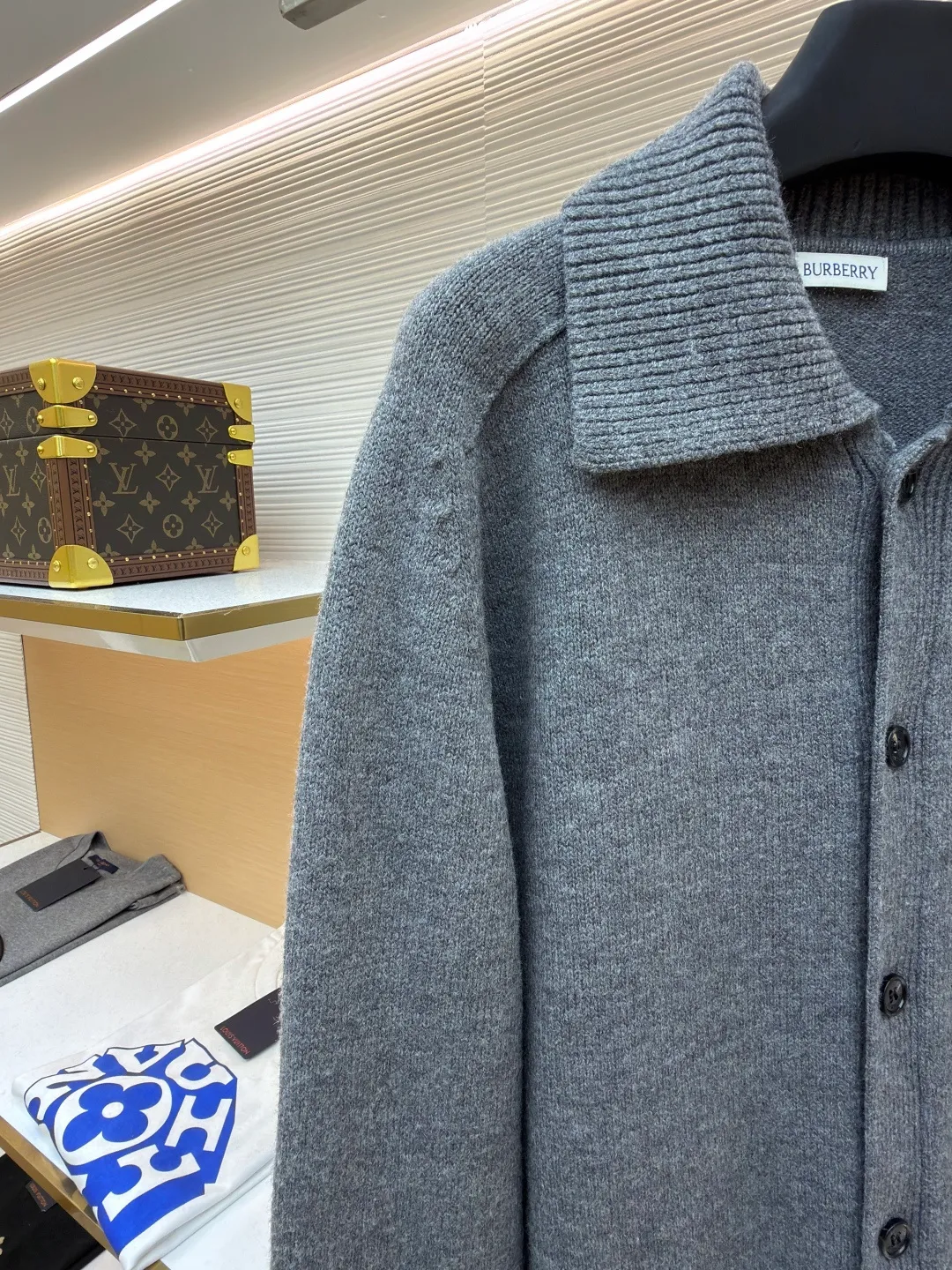 Burberry lapel rib knitted cashmere sweater ●Original version: purchased and developed by 11575 ●Item number: 1682227-B15 ●Fabric: wool blended fabric ●Technology: knitted ●Color: gray ●Version: fitted version ●Weight: about 580 grams ●Size: S-M-L-XL ●Description: This black knitted cardigan is knitted with high-count worsted wool yarn. The main body is built using four-flat stitch technology, which gives the fabric good elasticity and shapeability, while forming a fine and tight texture. The ribbed lapel weaving process is used at the neckline, and a combination of different needle types is used to create a crisp collar profile. The rib structure can be freely expanded and contracted according to the wearing status to fit the neck line. The placket adopts inlaid buttonhole technology and is matched with matte resin buttons of the same color. The buttons and the body are fixed by hand-stitching, which is strong and beautiful. The brand logo patch on the lower side of the body is processed by a hot-pressing bonding process and fits seamlessly with the knitted fabric. The overall cut is a slightly loose shoulder-drop version, combined with three-dimensional darting technology, which ensures wearing comfort while creating clean lines. Every knitting node is manually inspected to ensure the uniformity and integrity of the knitted texture. The overall wiring is straight and delicate, the fabric is comfortable and soft, and the color is consistent without color difference. It can be matched with the same style to create a fashionable look and control various occasions. Customized accessories, complete with three standards, same style for men and women!