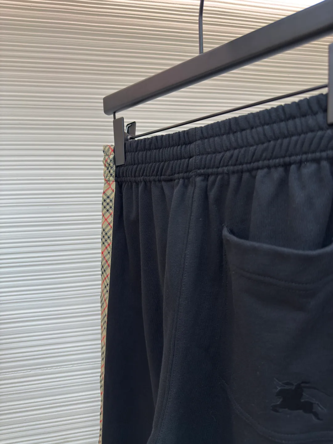 BURBERRY plaid webbing embroidered sweatpants ●Authentic product: purchased and developed by 3162 ●Item number: 1680514-A95 ●Fabric: single-sided fish scale fabric ●Technology: selvedge production ●Version: fitted version ●Weight: about 725 grams ●Size: S-M-L-XL ●Description: A single-sided fish-scale cloth fabric woven with cotton as the base. The front is a smooth knitted surface, and the skin-contacting surface is formed into three-dimensional terry by the floating thread knitting technology of the knitting machine, which increases the fluffiness and has a delicate touch. The terry structure absorbs a large amount of water and evaporates quickly, so it is not easy to loosen and deform after repeated washing. By actively interfering with the shrinkage potential of cotton fibers, the fabric is able to transition from changeable to stable, improving dimensional stability while being less prone to deformation and wrinkles. The monochrome flat embroidery on the chest uses the high-precision calculation system of the computer embroidery machine to control the coordinated operation of the machine head, needle bar, and thread spool. The fabric frame moves accurately in the horizontal and vertical directions to form a stitch track. The upper and lower thread tensions are adjusted to ensure that the stitches are smooth and free of floating threads, forming a fine pattern with an error of ±0.1mm. The overall wiring is straight and delicate, the fabric is comfortable and soft, and the color is consistent without color difference. It can be matched with the same style to create a fashionable look and control various occasions. Customized accessories, complete with three standards, same style for men and women!