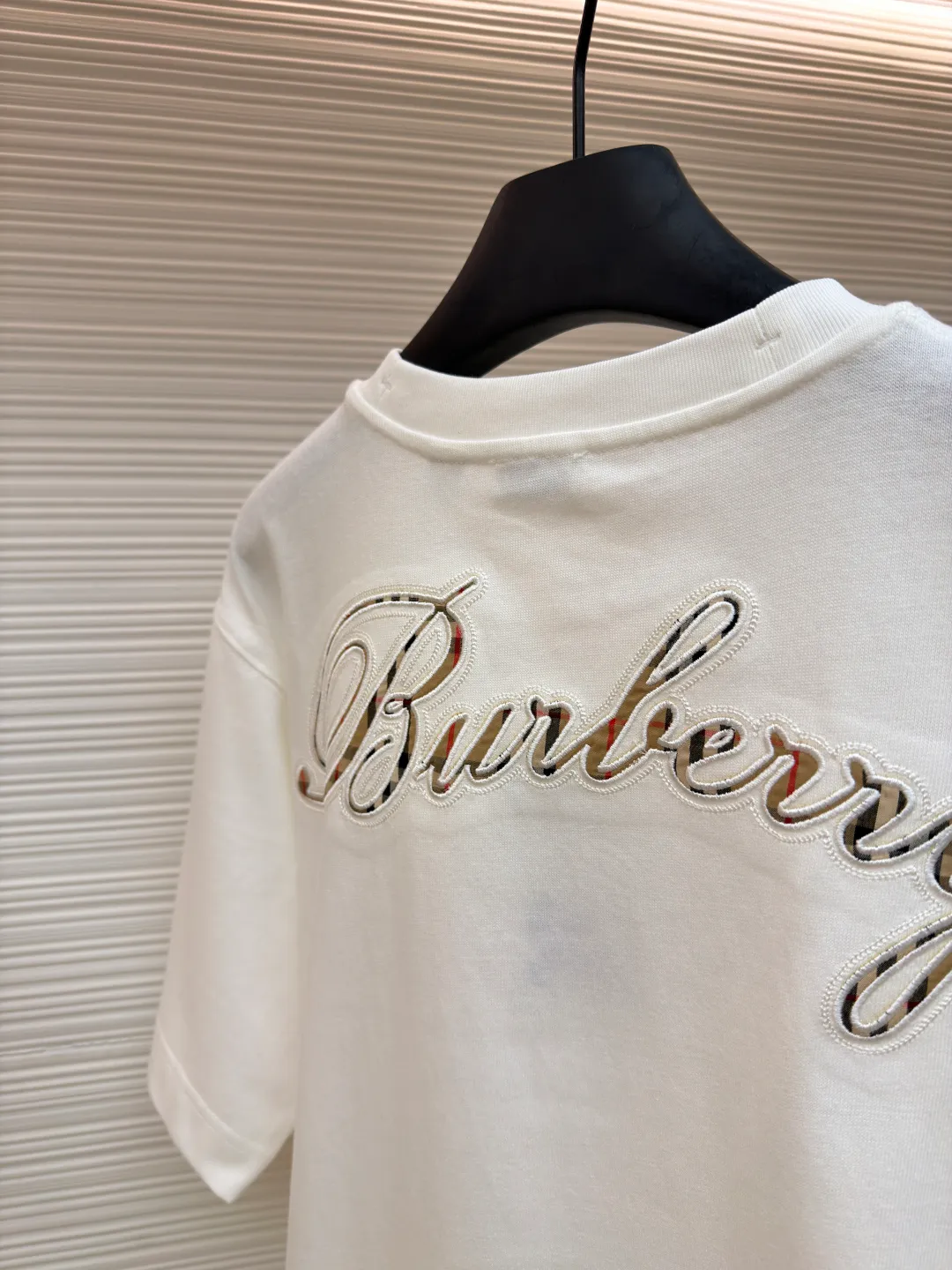 Burberry Plaid Back Letter Embroidery Round Neck Short Sleeve ●Original version: purchased and developed by 4984 ●Item number: 1681564-A10 ●Fabric: pure cotton fabric ●Technology: embroidery production ●Color: white ●Version: fitted version ●Weight: about 275 grams ●Size: XS-S-M-L ●Description: Made of 15S fine cotton plain weave, white/230g, black/310g; matching 32S double yarn tension frame thread, 300g. Made of pure cotton plain woven fabric, this weave has a tight structure, giving the fabric a crisp texture and excellent durability, while retaining the natural breathability and skin-friendly properties of cotton. The plain woven fabric is not easy to deform, avoids being too loose and casual, and provides a neater silhouette. The chest and back are embellished with letter logo embroidery, forming a visual rhythm that echoes the front and back, both presented through chain stitch embroidery technology. These logos also use high-precision embroidery technology to ensure clear edges, strong and durable. Unique embroidery technique, its stitches are interlocking like a chain, making it more three-dimensional, softer to the touch, and has a unique texture and luster. Presenting the classic plaid pattern with this process is an innovative deconstruction of the traditional elements of the brand. It transforms the original flat pattern into a three-dimensional texture with handicraft warmth, which greatly enhances the sophistication and value of the design. The overall wiring is straight and delicate, the fabric is comfortable and soft, and the color is consistent without color difference. It can be matched with the same style to create a fashionable look and control various occasions. Customized accessories, complete with three standards, same style for men and women!