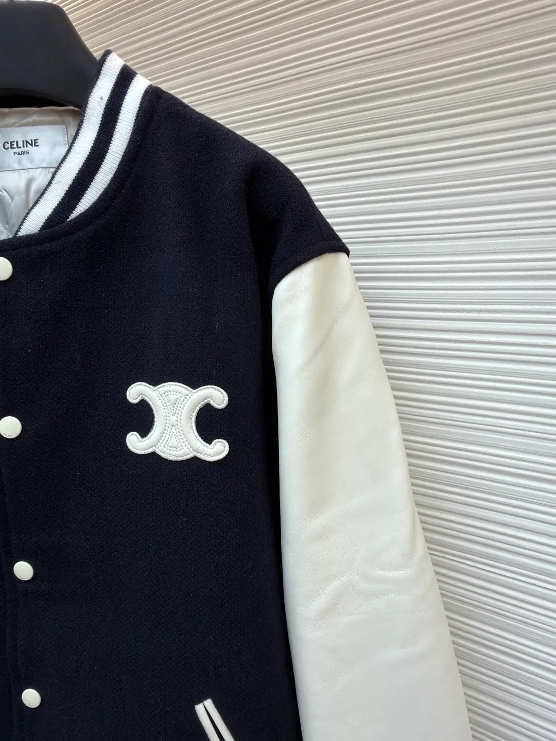 Celine genuine leather lettered baseball jersey ●Original version: Purchased and developed for 27500 ●Item number: 1681004-G25 ●Fabric: wool blended fabric ●Technology: laser burning production ●Version: fitted version ●Weight: about 1130 grams ●Size: 36-38-40-42 ●Description: The fabric is made of [50% wool + 50% acrylic blended yarn], [thick wool blended yarn], [rapier machine-dyed rice grain jacquard pattern], [gram weight 600g], matching [rayon cotton 4*4 diamond checkered lining], using [800# specification washed cotton] One-inch 9-needle spacing quilted embroidery], sleeve pocket lips + front and rear chapters are made of [fetal sheepskin], spray-painted according to the Y version color, the front chapter is [laser burnt] with genuine leather patch, and the inside is filled with [sponge embroidery machine embroidery], the back chapter is filled with [silicone material], and [electric hydraulic pressure]. Device three-dimensional embossing], open letter mold to punch out a single letter, [manual oil edge sealing], [manual sweeping powder positioning] letter spacing, pattern machine thick line carving letters, ribbing using [30% wool + 70% cotton blended yarn], jacquard yarn dyeing in intermediate colors, matching CE letter color round snap button. The overall wiring is straight and delicate, the fabric is comfortable and soft, and the color is consistent without color difference. It can be matched with the same style to create a fashionable look and control various occasions. Customized accessories, complete with three standards, same style for men and women!