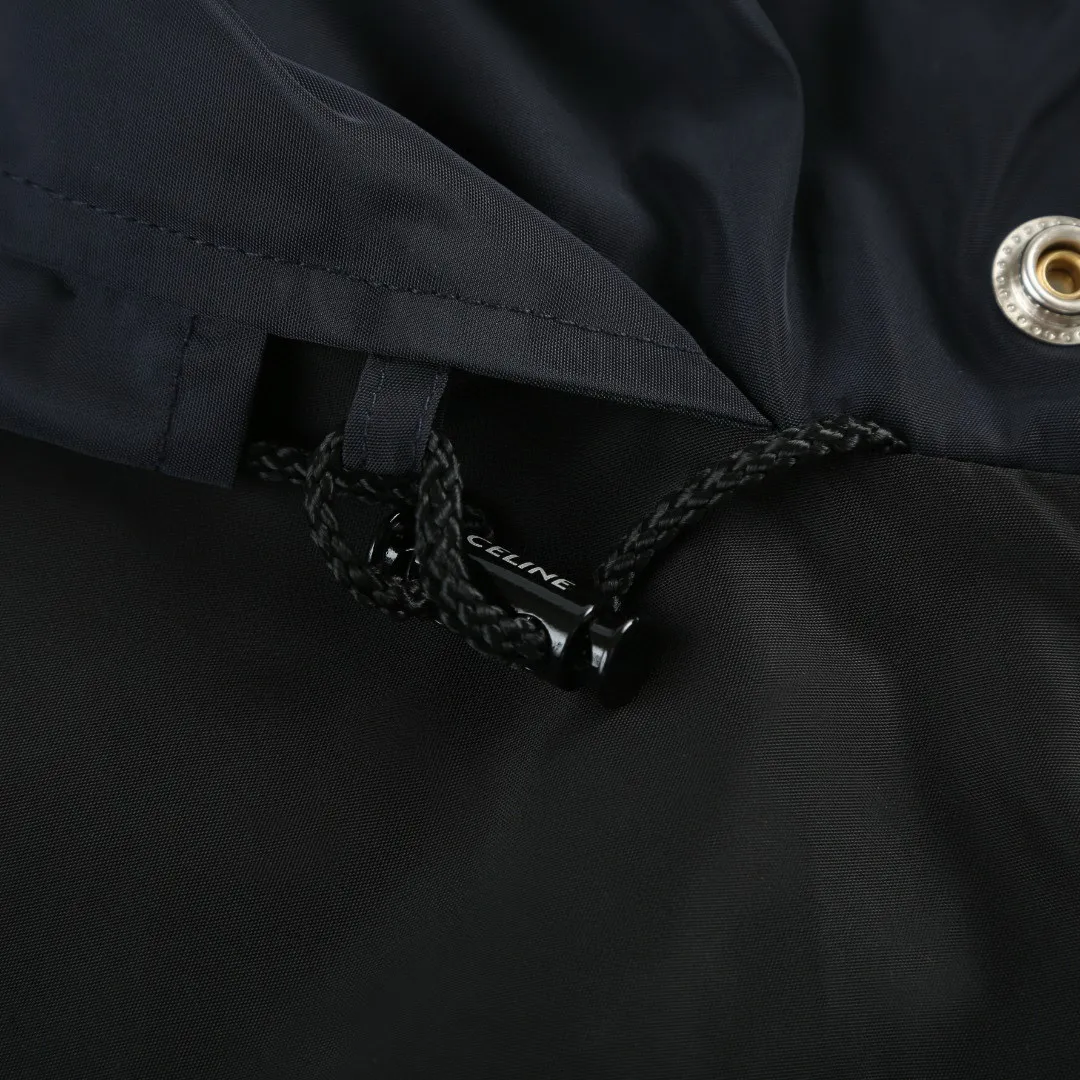 🅿️580 [Exclusive supply] Celine logo embroidered splicing windbreaker jacket. The fabric is made of oxford fabric made of 100% polyester fiber. The fiber properties have good toughness, and the lattice-like weave structure of Oxford cloth makes the fabric structure tight, very resistant to pulling and abrasion, and at the same time it has certain water-repellent properties. The density of polyester fiber itself is not high. While providing high strength, it maintains a relatively light weight and is easy to wear. By setting an extremely high stitch density on the computer embroidery machine, the fabric and backing are tightly fixed on the frame of the embroidery machine, with even and just the right tension. The double-axis linear guide drives the embroidery frame, and the frame moving accuracy can reach 0.01mm/P, ensuring precise positioning and the embroidery pattern completely covering the base fabric. The zipper and 6 snap-button closures engraved with CELINE provide double protection. Size:46-48-50-52