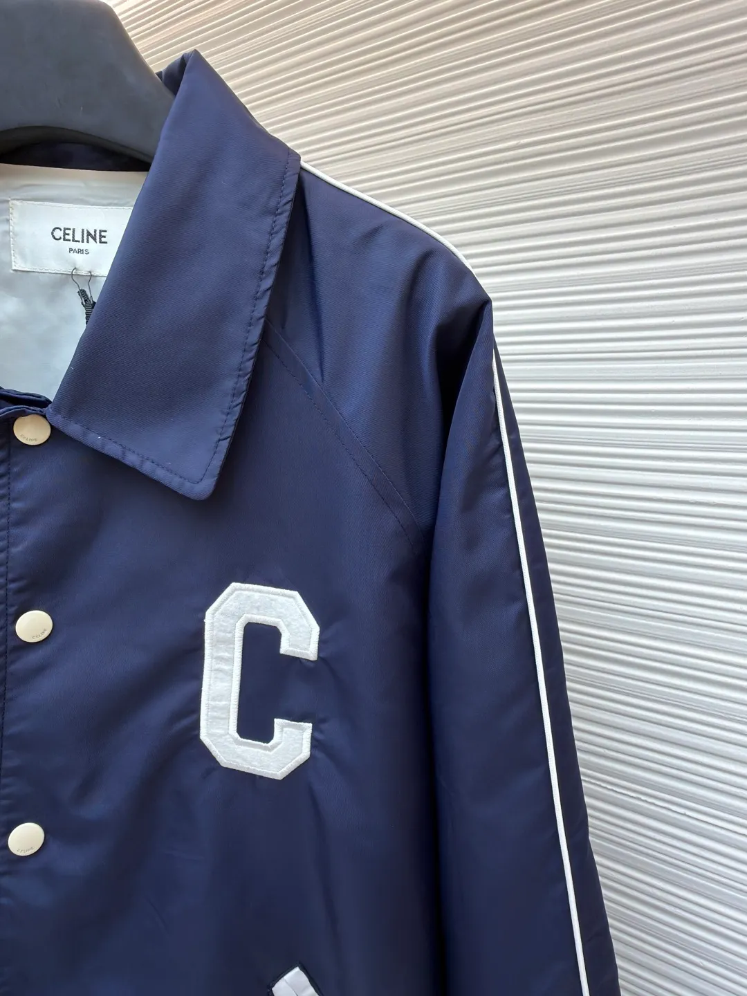Celine college style baseball uniform ●Original version: Purchased and developed by 10213 ●Item number: 1680910-B90 ●Fabric: nylon fabric ●Technology: embroidery production ●Version: fitted version ●Weight: about 600 grams ●Size: 46-48-50-52 ●Description: This baseball uniform is made of blue satin nylon fabric. The front and back are designed with S's exclusive embroidery process. It has metal engraved four-button closures and a contrasting striped rib design on the hem and cuffs. The style is very novel and unique. It can be easily worn with T-shirts and jeans. It is the same style for men and women. Highly recommended! The overall wiring is straight and delicate, the fabric is comfortable and soft, and the color is consistent without color difference. It can be matched with the same style to create a fashionable look and control various occasions. Customized accessories, complete with three standards, same style for men and women!