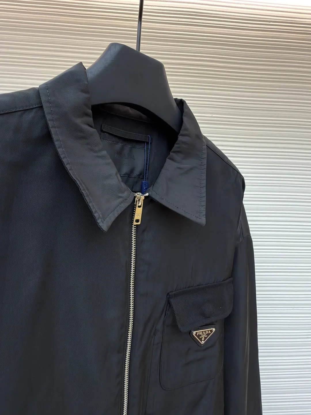 Prada solid color logo zipper lapel long-sleeved jacket ●Original version: purchased and developed by 7262 ●Item number: 1681635-B05 ●Fabric: nylon twill high-count and high-density windbreaker fabric ●Technology: Positioned cutting machine production ●Color: black ●Version: fitted version ●Weight: about 465 grams ●Size: S-M-L-XL ●Description: This Prada jacket is made of high-quality waterproof and windproof fabric, which feels crisp and breathable. The three-dimensional tailoring fits the body shape, and the lapel design with smooth zipper closure makes it neat and stylish to wear. The brand triangle metal logo on the chest highlights the brand identity, and the details are exquisite. The body of the garment has a rigorous structure, and the splicing uses flat-turn open-stitching technology. The stitches are even and flat, and the lines are clear and smooth. The pocket design is practical and beautiful, and the edges are reinforced to ensure durability. The elastic hems on the hem and cuffs are windproof, warm and flattering. The entire jacket embodies Prada's ultimate pursuit of quality and craftsmanship from fabric selection, tailoring to detail processing. It not only retains the elegant style of classic items, but also incorporates modern design language, making it suitable for a variety of occasions. The overall wiring is straight and delicate, the fabric is comfortable and soft, and the color is consistent without color difference. It can be matched with the same style to create a fashionable look and control various occasions. Customized accessories, complete with three standards, same style for men and women!