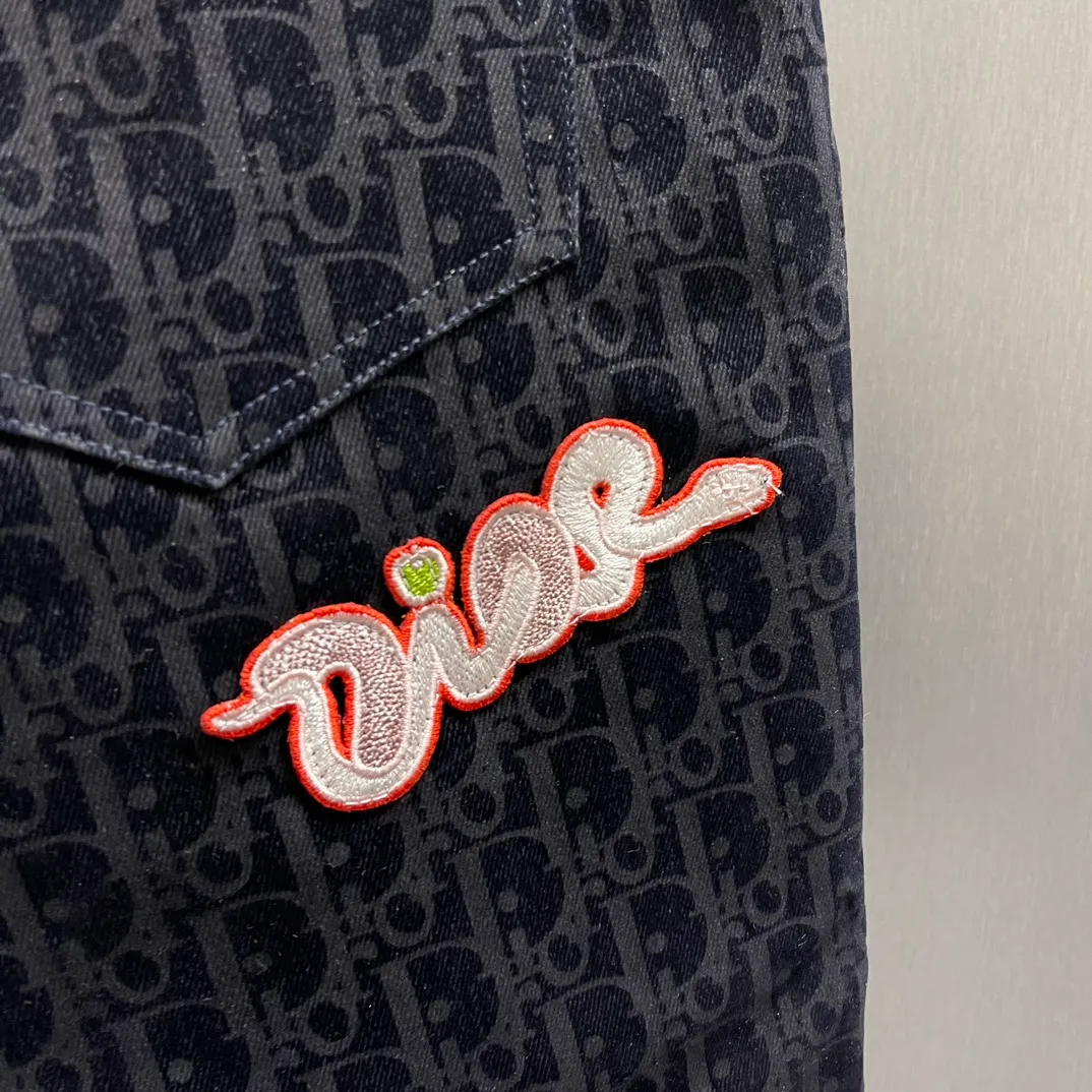 🅿️490 🧧CD Fully Printed Year of the Snake Embroidered Shorts Size: S-XL Dio* brand shorts are overall dark blue and covered with the classic "CD" presbyopia pattern, which is highly recognizable for the brand. There is a Dior brand tag hanging on the front, and a bright "Dio*" embroidered logo on the back pocket, adding to the fashion sense. The style is simple and the pocket design is practical, suitable for daily casual wear.