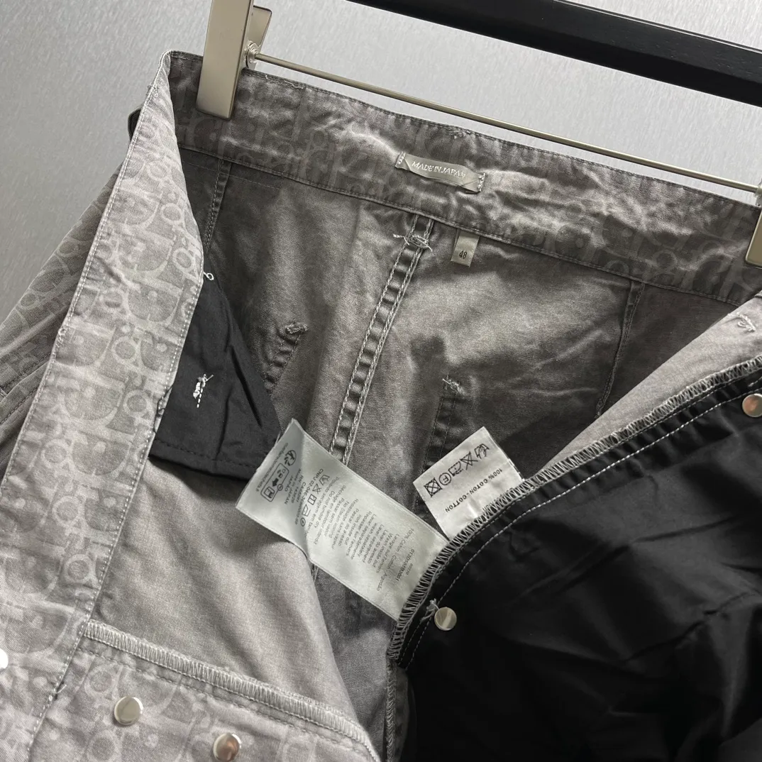 🅿️510 🧧CD Gray Cotton Denim Oblique Print Pants These work jeans display Oblique print, reinterpreting workwear style with a casual cut. Crafted from gray cotton denim and finished with classic . Blique print for an elegant look. Pair with the matching village shirt for a graphic look.