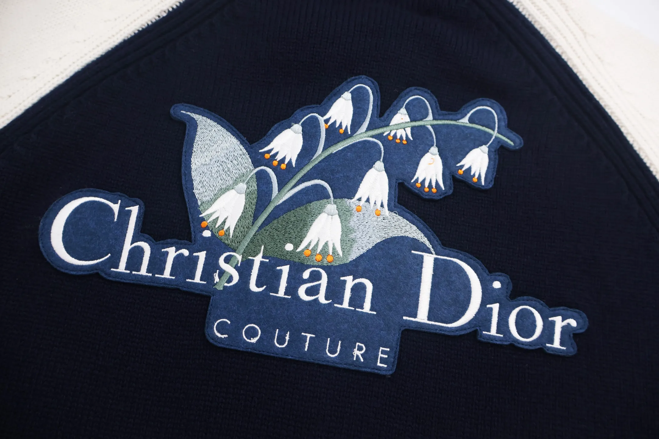 🅿️800 [Exclusive supply] CD lily of the valley embroidered college style zipper knitted jacket. This Christian Dr Couture lily of the valley embroidered two-color college style cardigan is a new product in the 2025 autumn men's wear series, reinterpreting college style with a color-blocking design. Crafted from blue and beige jersey felt, it features contrasting pockets and sleeves. Decorated with Christian Dr Couture embroidery and accented with beads and lily of the valley flowers, it pays homage to Mr. Dr's love of flowers. Pair with other pieces from the collection for a sophisticated look. Size:S-M-L