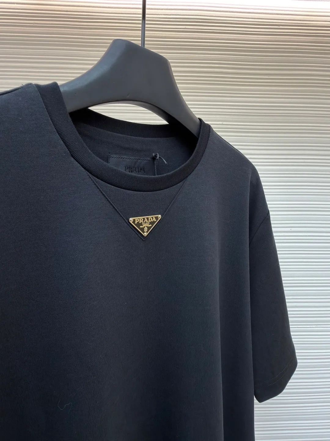 Prada chest triangle logo short sleeves ●Original version: 8000 purchase and development ●Item number: 1682414-A00 ●Fabric: 100% cotton fabric ●Technology: infrared positioning production ●Color: black ●Version: Fitted version ●Weight: about 315 grams ●Size: S-M-L-XL ●Description: Customized mercerized hydrogen and oxygen liquid ammonia double-sided satin, breathable and refreshing, comfortable and skin-friendly. The iconic Prada triangle logo embellishes the chest to highlight the brand charm. The unique design of splicing the triangle area of the neckline creates a full sense of layering. It shocks your vision with a minimalist design and highlights luxury in a low-key manner. The infrared positioning of the "Prada triangle mark" is made using an imported special machine to make the position more precise and firm. Manual point splicing of the triangular area is carried out with the triangular fabric through precise point selection to ensure that the triangular area is uniformly positioned. The fabrics have been washed and have a better hand feel and texture. It is not easy to deform, shrink or fade, and maintains long-term beauty. The overall wiring is straight and delicate, the fabric is comfortable and soft, and the color is consistent without color difference. It can be matched with the same style to create a fashionable look and control various occasions. Customized accessories, complete with three standards, same style for men and women!