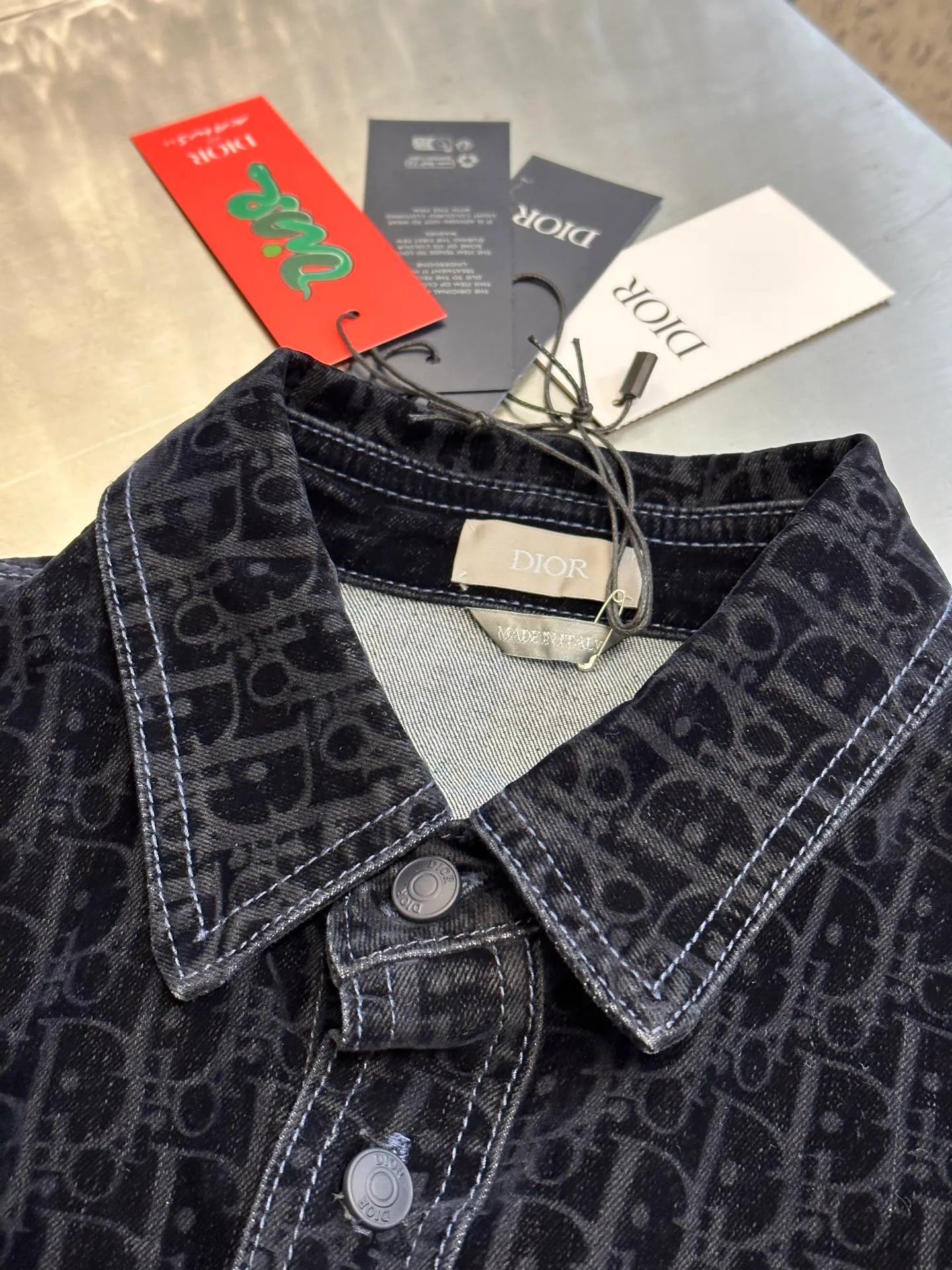 🅿️680 Dior x KAWS joint denim jacket This jacket and shirt is from the DIOR AND KAWS limited series. Crafted from blue cotton-blend denim, it features the classic Oblique print throughout and a green DIOR AND KAWS embroidered patch that reinterprets the Dior logo in a colorful snake shape. Featuring two chest patch pockets, it can be paired with jeans or shorts for a casual yet stylish look.  size:37.38.40.42.44
