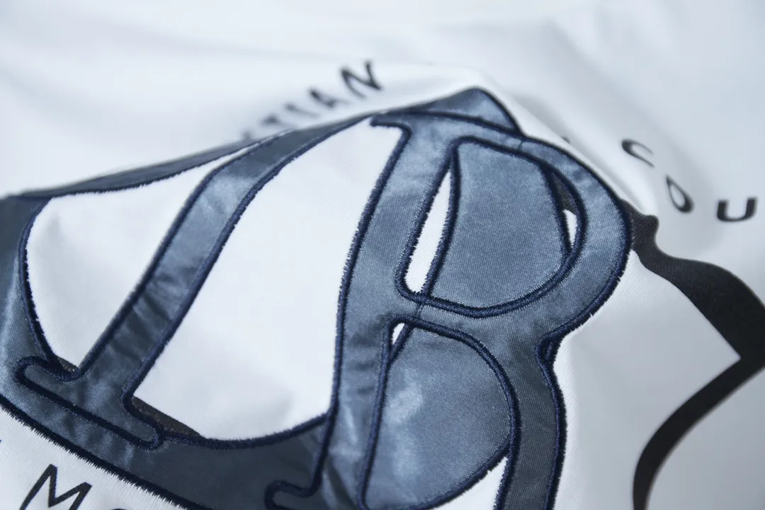 🅿️200 High Quality This T-shirt is decorated with Dior Charm logo print and embroidery, paying tribute to Dior's classic logo. Crafted from white cotton jersey with a classic ribbed crew neck. Casual and versatile, it can be paired with a variety of casual outfits to create a sophisticated look. In the penetration glue printing process, printing dyes and chemical gels are required to ensure that the printing effect is bright and strong. At the same time, in order to obtain better penetration effect, the glue has very good coverage and has a certain gloss. Combined with the patch printing process, patch embroidery, also known as applique embroidery, is a form of embroidery in which other fabrics are cut and sewn onto clothing. The stitching method is used to lock the edges so that the threads or rough areas on the outer edge of the fabric are not exposed, highlighting the styling. S M L XL S M L XL