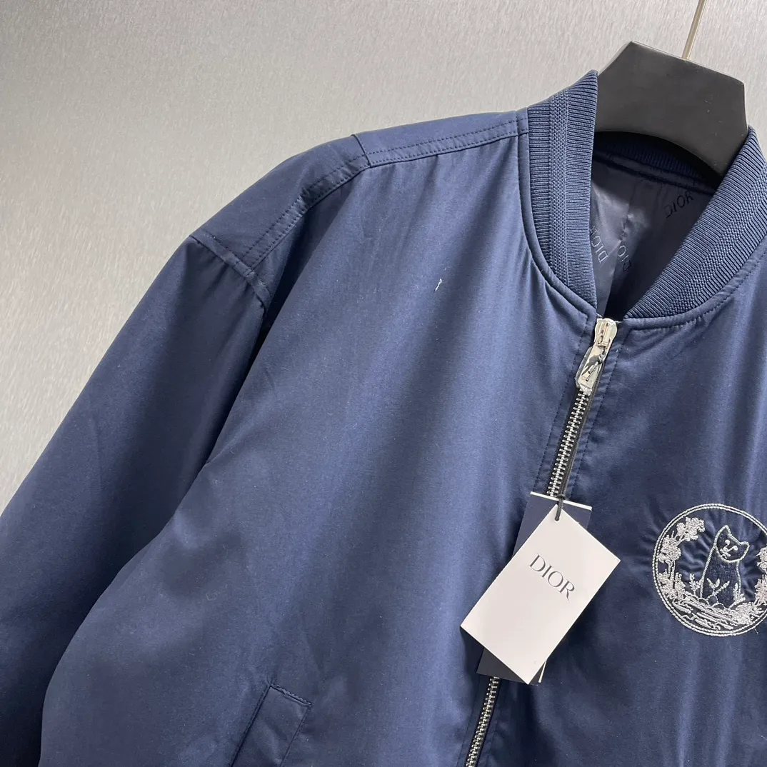 🅿️700 🧧CD Star Embroidered Bomber Jacket SIZE: S-XL This bomber jacket displays the Dior For My Real Friends logo from the DIOR AND HYLTON NEL collaboration. Crafted from navy cotton-blend in a comfortable fit with ribbed trim and welt pockets, it's embroidered with the collection's signature on the front and back. Wear it with a variety of everyday outfits.