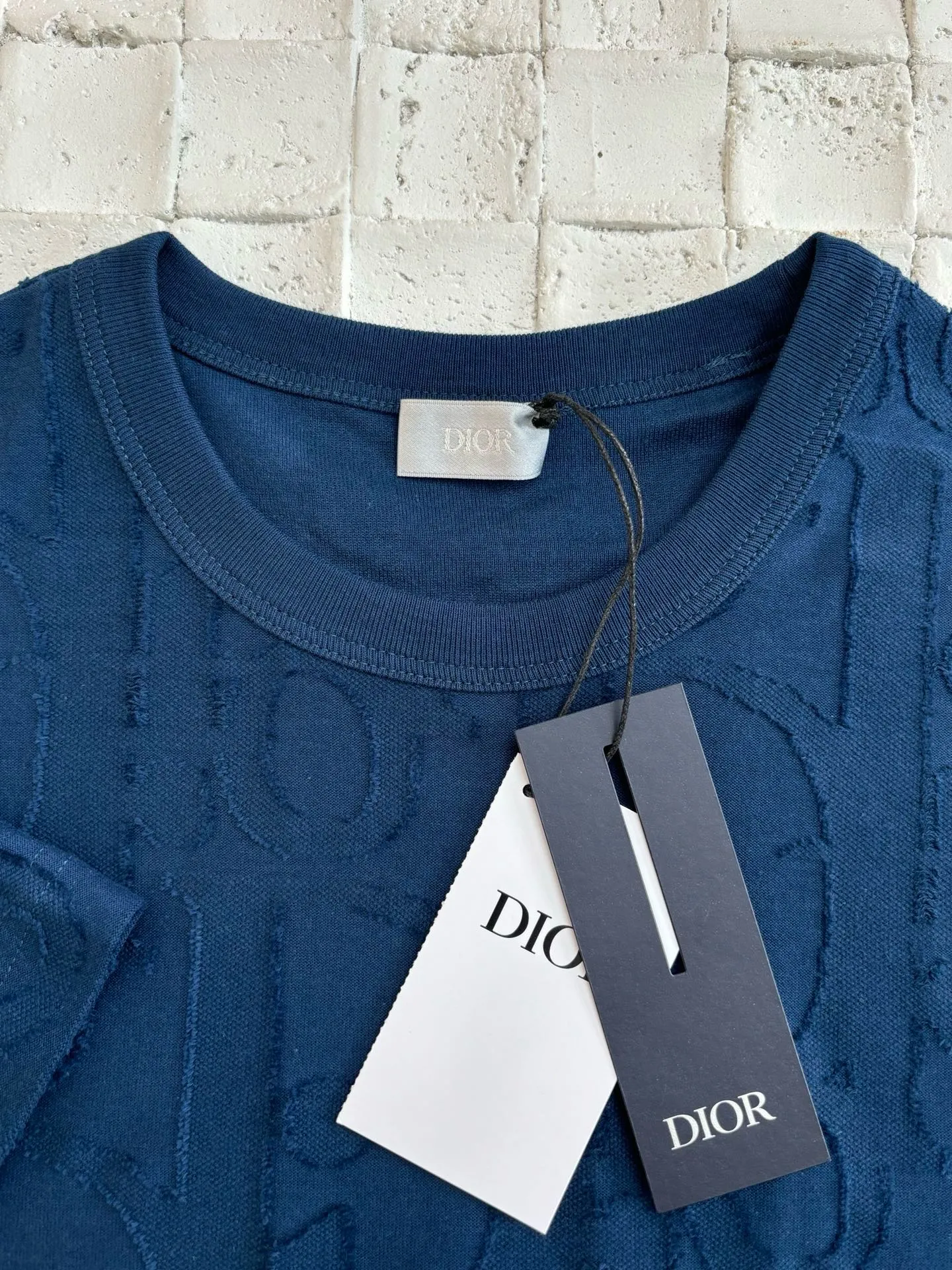 🅿️296 Dio*/Dior 25Ss new line-cut jacquard round-neck short-sleeved T-shirt. Pure cotton plain weave fabric, woven with 32S double-ply pure cotton yarn. The fabric has high abrasion resistance while retaining the moisture absorption and breathability of pure cotton. The plain weave has a tight structure and a smooth surface, but it feels relatively stiff and supports the stiffness of the version. Jacquard pattern, line-cut jacquard technology, full-width Oblique jacquard pattern The relief effect is formed through the deep integration of full-width jacquard and shearing process. The jacquard structure provides a three-dimensional skeleton, and the shearing process strengthens the local texture. Electronic jacquard machine weaves complex patterns on the entire fabric, forming a three-dimensional concave and convex texture to achieve the integration of texture and pattern. The raised jacquard is directionally sheared to form a relief effect, enhancing the tactile level and visual contrast. Size: S/M/L/XL