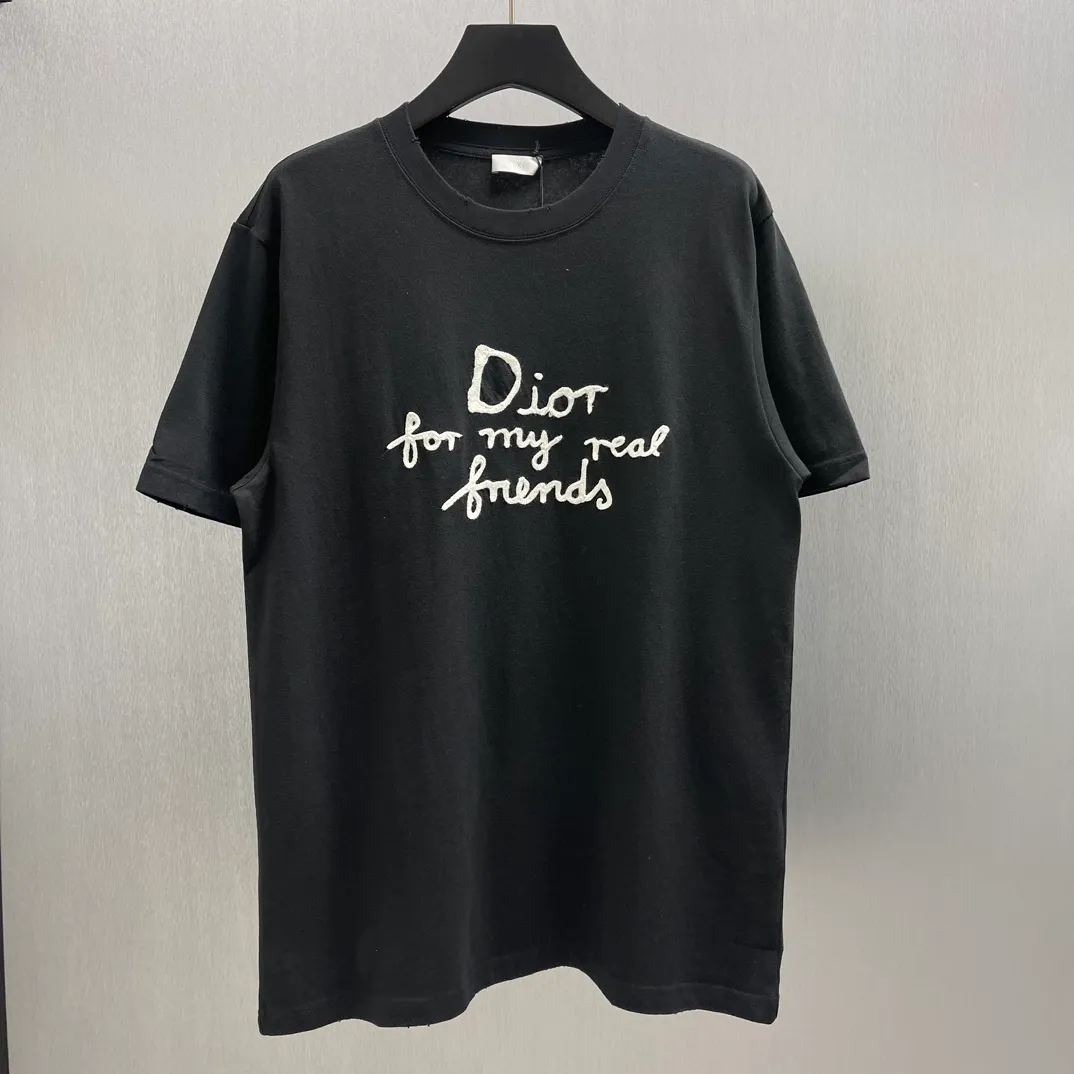 🅿️260 🧧CD True Friends Private Lettered Short Sleeves Size: S-XL This T-shirt displays the Dior For My Real Friends logo from the DIOR AND HYLTON NEL joint series. Crafted from black cotton jersey, it features a classic silhouette with a ribbed crew neck, embroidery on the chest for added style, and a burned-out effect on the collar, sleeves and hem. Cut for a relaxed fit, wear it with track pants or jeans.