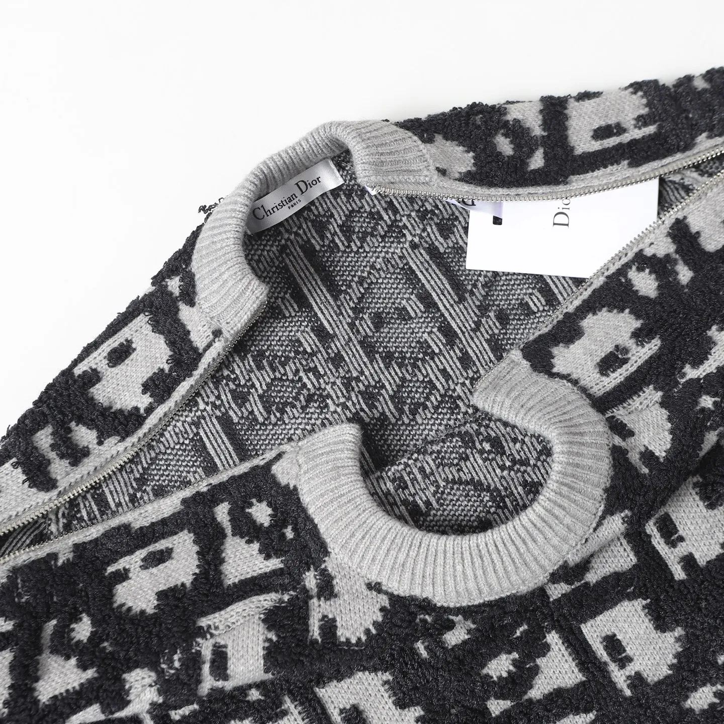🅿️450 CD Home Jacquard Fabric Oblique Printed Sweater Details and Features This sweater reinterprets the Dior classic logo from a fashionable and modern perspective. Crafted from blended jacquard fabric, it's accentuated with a raised all-over classic light green Oblique print. Zippered sleeves add style, while a ribbed crew neck adds contrasting texture. Wear it with jeans for a graphic, casual look. All-over Oblique print sleeves with zip closure Contrasting ribbed crew neck Size: S M L