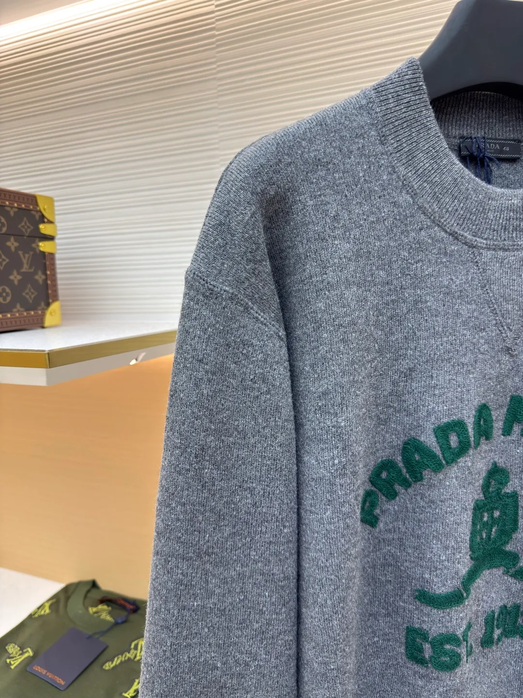 Prada music logo embroidered knitted sweater ●Article number: 1680706-A85 ●Fabric: Jersey knitted fabric ●Technology: Knitted embroidery production ●Version: Fitted version ●Weight: about 560 grams ●Size: S-M-L-XL ●Description: The "V-shaped design thread" on the neckline is by no means an ordinary stitch, but a functional and decorative craft. The highlight of chain-style towel embroidery is the special embroidery technique, which uses repeated chain stitches to form a continuous, raised towel-like coil effect pattern that appears on the cloth with a strong three-dimensional effect, soft and fluffy to the touch, and highly recognizable. It presents a terry-like texture, forming an interesting contrast with the smooth underside of the sweater, enriching the visual and tactile layers. The chain structure makes the embroidery not easy to snag or fall off, and has good durability. The collar, cuffs and hem are all ribbed; the excellent lateral elasticity of the ribbed tissue not only ensures that the key parts of the body are firm and not easily deformed, durable and washable, but can also be tightened naturally to outline a neat outline. Its functionality and decoration coexist: it not only prevents the intrusion of cold wind and improves thermal insulation efficiency, but also adds a sense of rhythm in details to the overall simple design, making the shape more crisp. The overall wiring is straight and delicate, the fabric is comfortable and soft, and the color is consistent without color difference. It can be matched with the same style to create a fashionable look and control various occasions. Customized accessories, complete with three standards, same style for men and women!