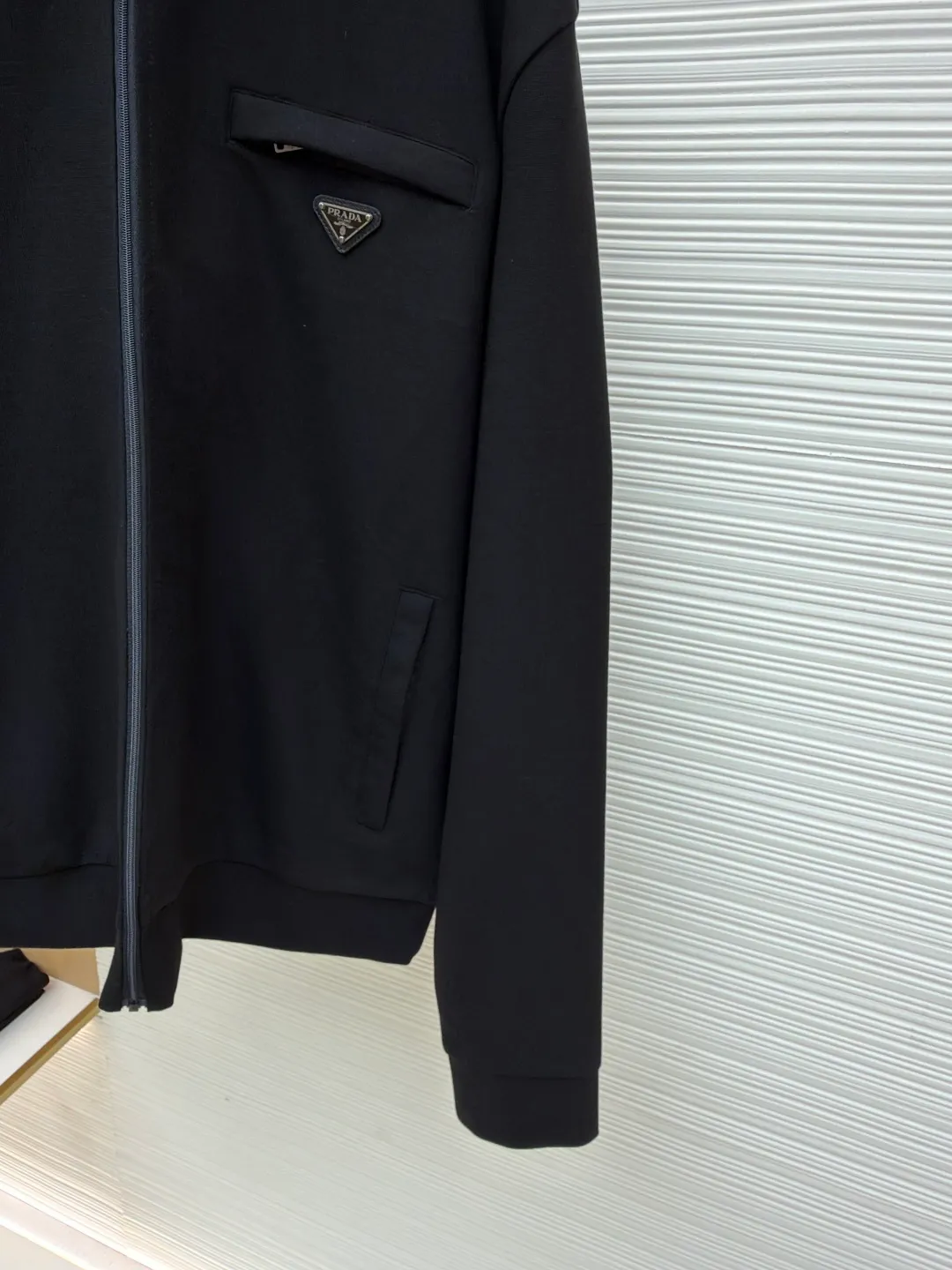 Prada triangle zipper jacket ●Original version: Purchased and developed for 22800 ●Item number: 1681210-B35 ●Fabric: photo-activated energy technology cotton fabric ●Technology: fabric washing and production ●Color: black ●Version: fitted version ●Weight: about 800 grams ●Size: S-M-L-XL ●Description: Customized photo-activated technology cotton Breathable air cotton Enjoy the cloud cotton feel Soft and waxy to the touch The main tone is deep matte black, exuding an innate sense of luxury. The iconic triangular logo is embellished on the chest pocket, highlighting the elegance and nobility of the brand. It is characterized by a square cut and a stand-up collar. It outlines the neat shoulder line and straight body. It is versatile and interprets the true connotation of high-end fashion. It uses imported special machine infrared to locate the "Prada triangle mark" for more precise positioning. It is firm and strong, and the template machine opens the bag. The preset template guides the position, shape and size of the bag opening. The accuracy ensures the quality of the bag opening effect. The fabrics are washed and have a better hand feel. They are not easy to deform, shrink or fade, and maintain long-term beauty. The overall wiring is straight and delicate, the fabric is comfortable and soft, and the color is consistent without color difference. It can be matched with the same style to create a fashionable look and control various occasions. Customized accessories, complete with three standards, same style for men and women!