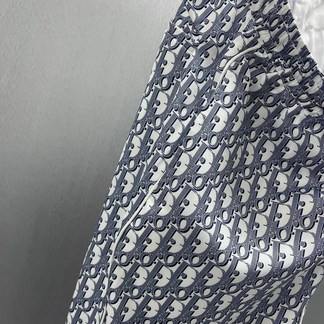 🅿️430 🧧CD Allover Printed Presbyopic Pajama Pants Size: S-XL These pajamas feature the brand’s classic Oblique print all over. Crafted from white and blue mulberry silk twill, it features an elasticated drawstring waistband, side slit pockets and rear welt pockets.