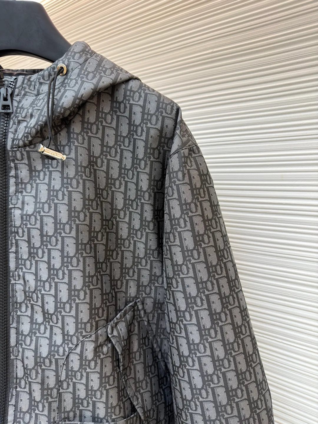 Dior Oblique full-width jacquard printed hooded jacket ●Original version: purchased and developed by 22785 ●Item number: 1681741-C45 ●Fabric: taffeta technical jacquard fabric ●Technology: printing production ●Color: gray ●Version: fitted version ●Weight: about 635 grams ●Size: S-M-L-XL ●Description: Carefully made of blue taffeta technical jacquard fabric, with front zipper closure, two flap pockets and two snap patch pockets, and a drawstring hood design for good protection. It is embellished with bee logo embroidery and can be matched with other Oblique printed items. The overall line is straight and delicate, the fabric is comfortable and soft, and the color is consistent without color difference. It can be matched with the same style to create a fashionable look and control various occasions. Customized accessories, complete with three labels, same style for men and women!