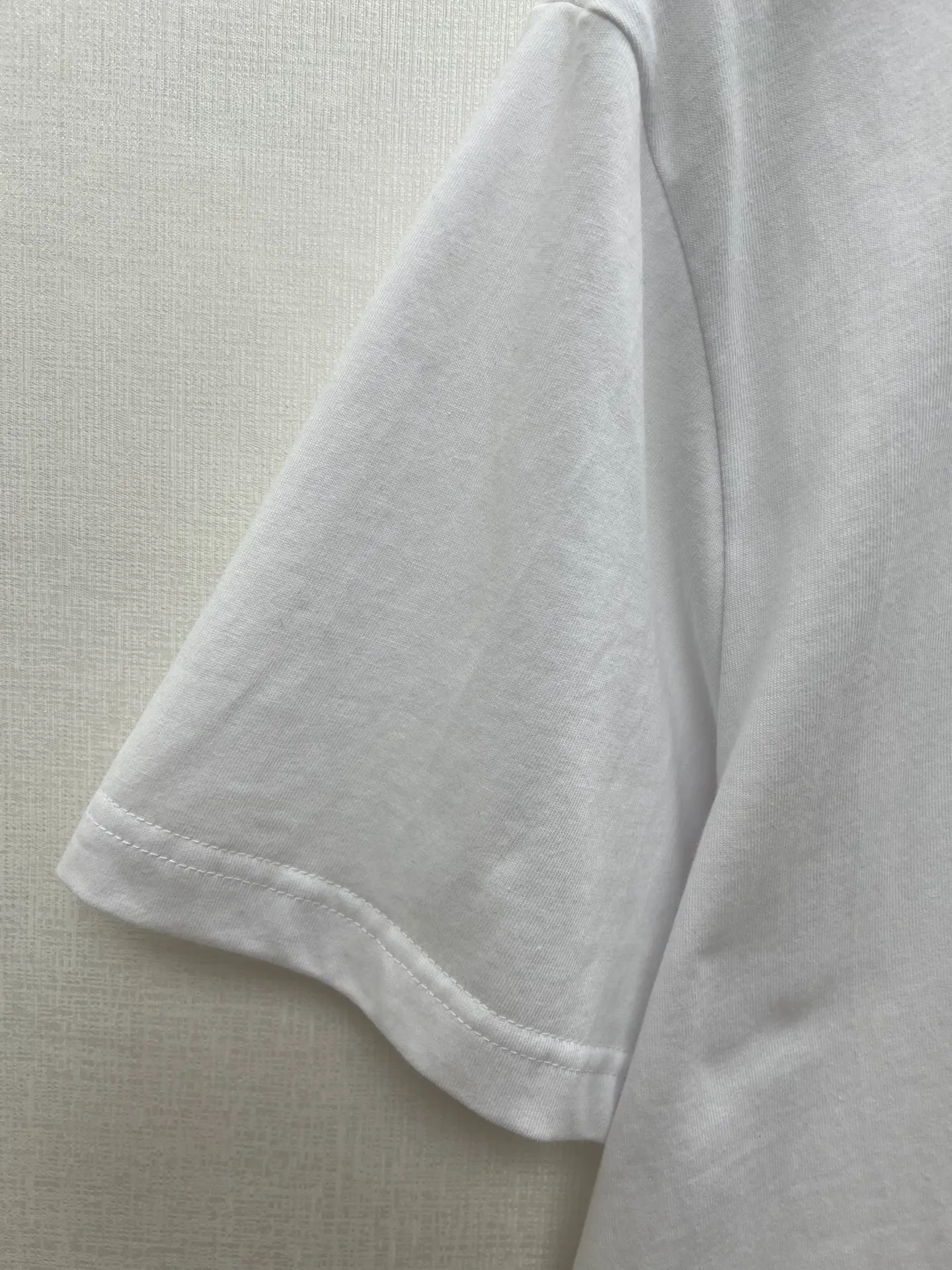 🅿️240 Dior 25ss new T-shirt is a new product of the 2025 autumn men's wear series, from the DIOR AND LEWIS HAMILTON limited series. Crafted from white cotton jersey, it has a ribbed neckline decorated with the collection's signature, a graphic reinterpretation of the Dior logo. Wear it with the collaboration's trousers for a sophisticated look. Size: S.M.L.XL.
