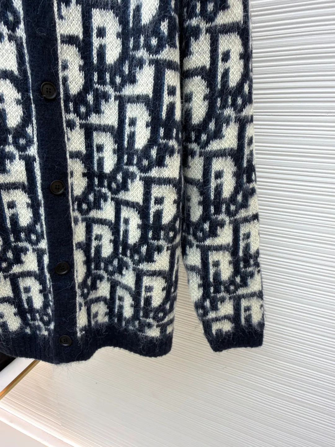 Dior mohair knitted cardigan ●Original version: Purchased and developed at 17989 ●Item number: 1681345-B60 ●Fabric: mohair fabric ●Technology: Knitted production ●Color: black and white ●Type: Fitted version ●Weight: about 705 grams ●Size: S-M-L-XL ●Description: This cardigan is made of mohair blended fabric, which is soft to the touch and has a fluffy texture. The brand's classic letter jacquard is displayed all over the body, which is realized through two-color knitting technology. The pattern texture is clear and three-dimensional, and the colors are distinct. The round neck design is processed by ribbing edge processing, and the neckline is stiff and not easy to deform; the placket is equipped with retro metal buttons, the color is old and echoes the overall style. The ribs on the cuffs and hem are made of high-elastic knitting technology to ensure good fit and resilience. The overall cut is a loose fit, and the splicing of the body uses seamless weaving technology to avoid exposed threads and improve wearing comfort. From jacquard craftsmanship to detail processing, every step reflects the exquisite control of luxury knitwear. It is a fusion of the brand's classic elements and high-end knitting craftsmanship. The overall wiring is straight and delicate, the fabric is comfortable and soft, and the color is consistent without color difference. It can be matched with the same style to create a fashionable look and control various occasions. Customized accessories, complete with three standards, same style for men and women!